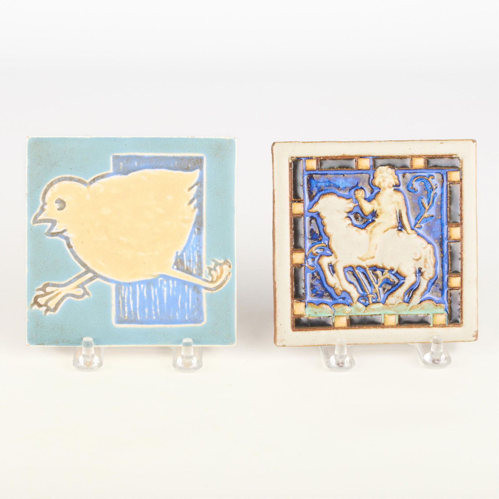 2 Mosaic Tile Co. Arts & Crafts Pictorial Tiles: Mosaic Tile Company, Zanesville, Ohio. Group of two American Arts & Crafts ceramic pictorial pottery tiles, early 20th century. Including one depicting a chick in stride and a second tile depicting a