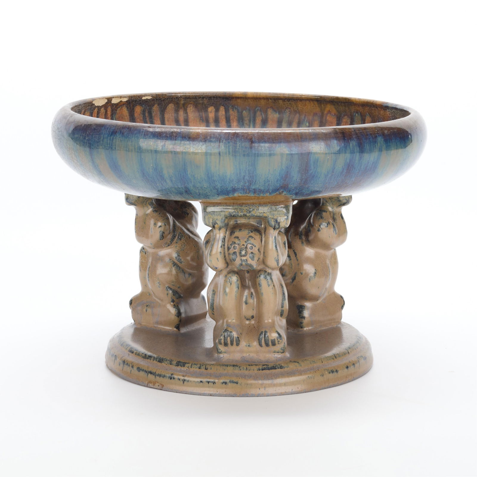 Fulper Art Pottery Figural Effigy Bowl: Fulper Pottery, New Jersey, United States. Art pottery "Effigy Bowl," ca. 1920. Earthenware with blue and purple flambe glazes. Depicting three stylized figures on a round base, holding a wide bowl wi