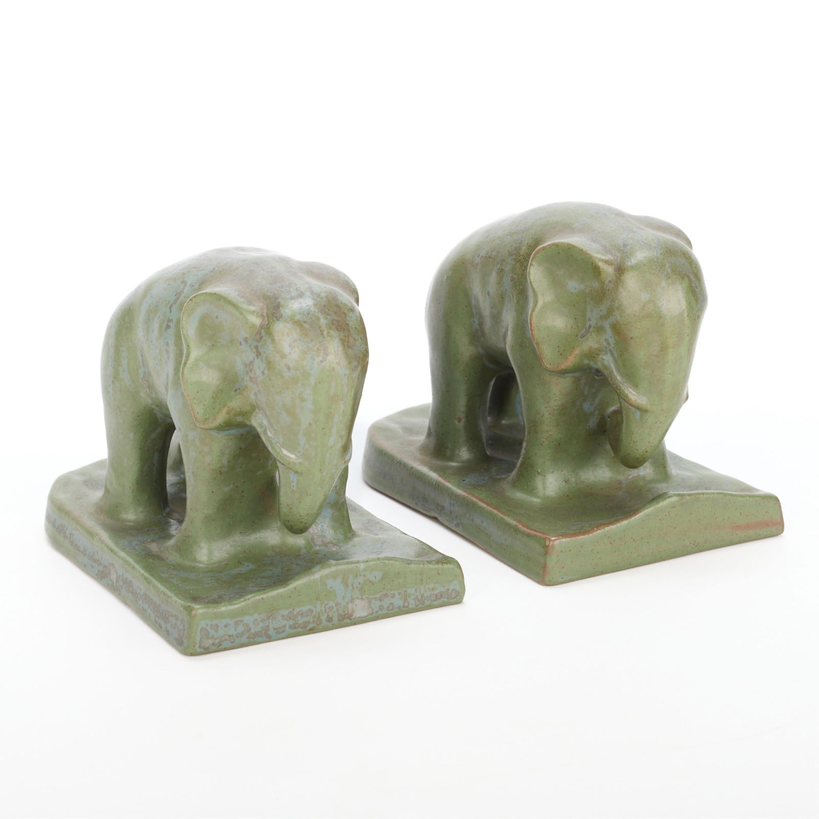 Fulper Art Pottery Matte Green Elephant Bookends: Fulper Pottery, New Jersey, United States. Pair of Arts & Crafts style pottery elephant form bookends, early 20th century. Stoneware with mottled matte green glaze.(Each) Height: 4 1/4 in x width: 6 i