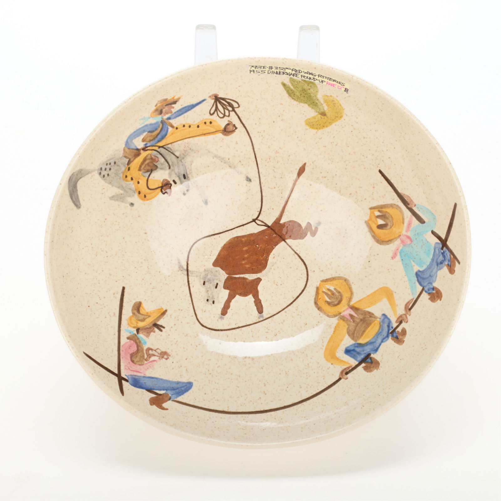 Red Wing Pottery "Round Up" Serving Bowl 1955: Red Wing Pottery, Minnesota. Mid-century art pottery "Round Up" dinnerware pattern serving bowl, ca. 1955. Depicting cowboys lassoing a bull and other Western motifs along the center. Ink-stamped