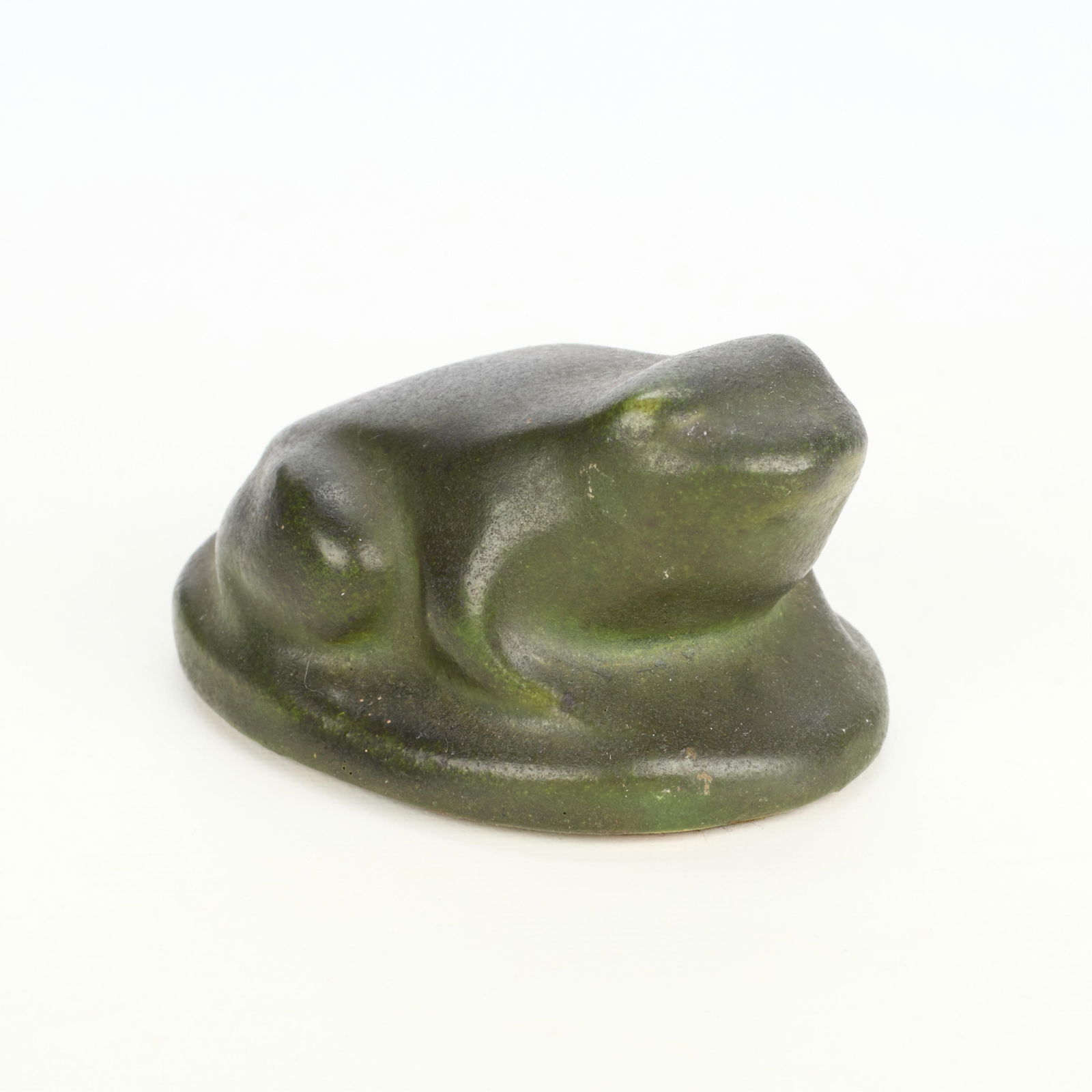 Handicraft Guild Arts & Crafts Ceramic Paperweight: Handicraft Guild of Minneapolis, Minnesota. Arts & Crafts art pottery paperweight or figurine in the form of a frog. Executed in a matte green glaze. Label affixed along the underside.Height: 2 in x w