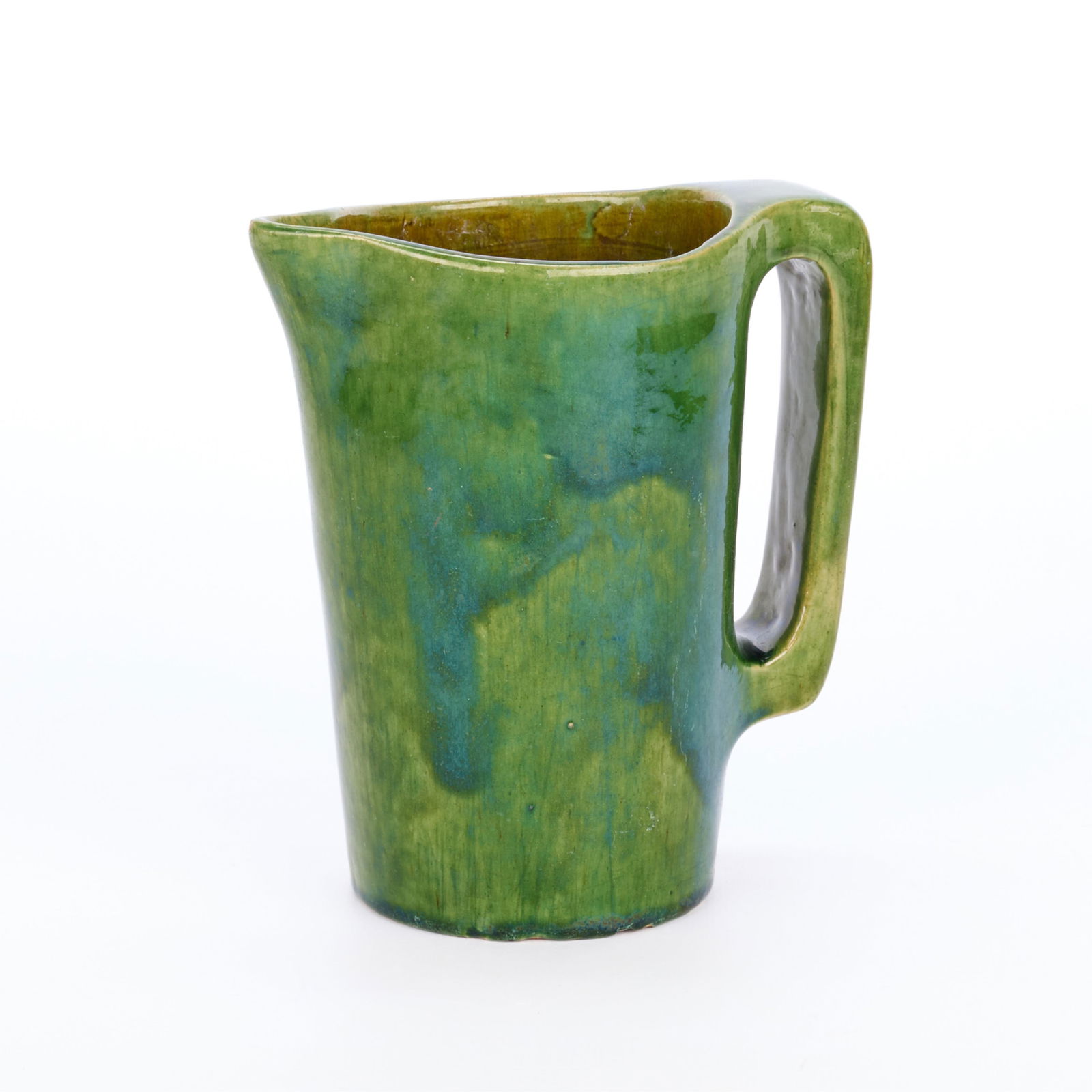 Handicraft Guild Arts & Crafts Ceramic Pitcher: Handicraft Guild of Minneapolis, Minnesota. Arts & Crafts pottery pitcher, ca. 1900s-1910s. Executed in a vibrant green glaze. Marked along the underside.Height: 6 in x width: 5 1/4 in x diameter: 3 1