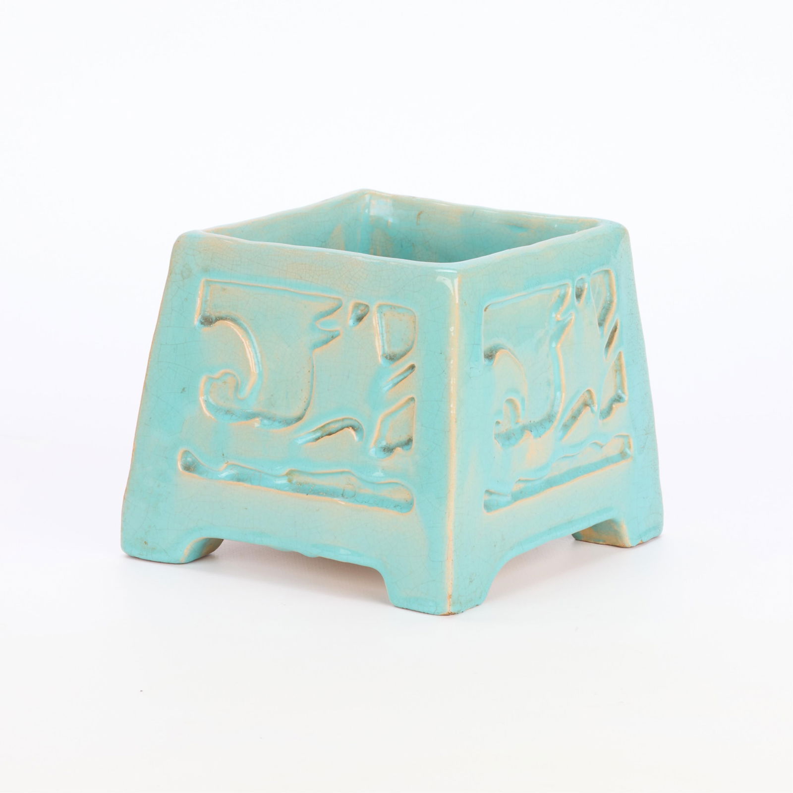 Signed Arts & Crafts Square Pottery Planter: Arts & Crafts ceramic planter of square form. Depicting abstract motifs. Executed in a light blue glossy glaze. Initialed "UMP" along the underside.Height: 5 in x width: 5 3/4 in depth: 5 3/4 in.