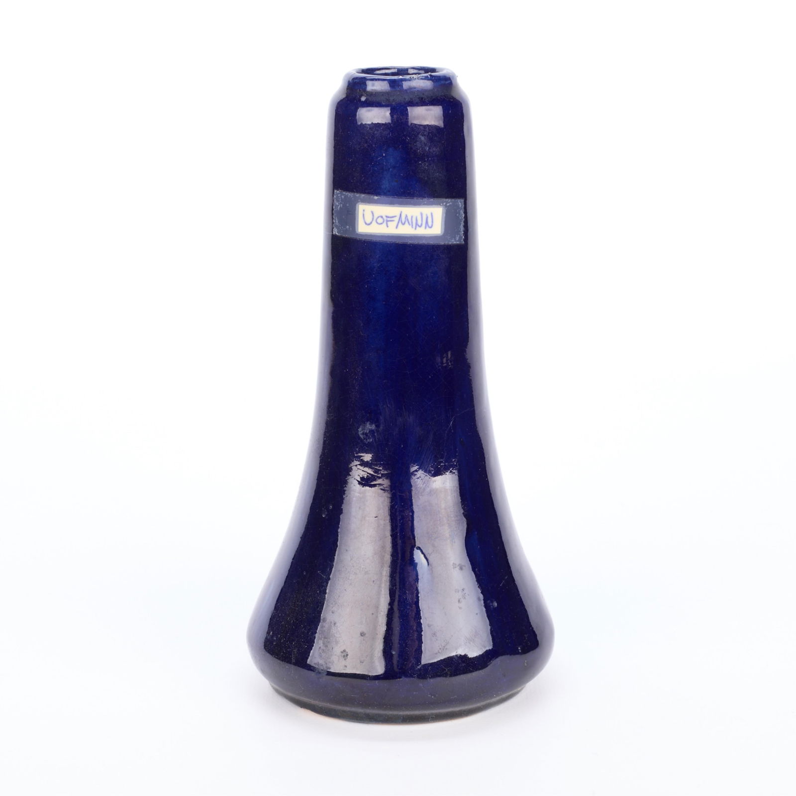 University of Minnesota Arts & Crafts Ceramic Vase: Arts & Crafts glazed pottery bud vase of elongated, cylindrical form, ca. early 20th century. Exeuted in a deep cobalt blue glaze. With a label, reading "U of Minn." Initialed "VMP" along the undersid