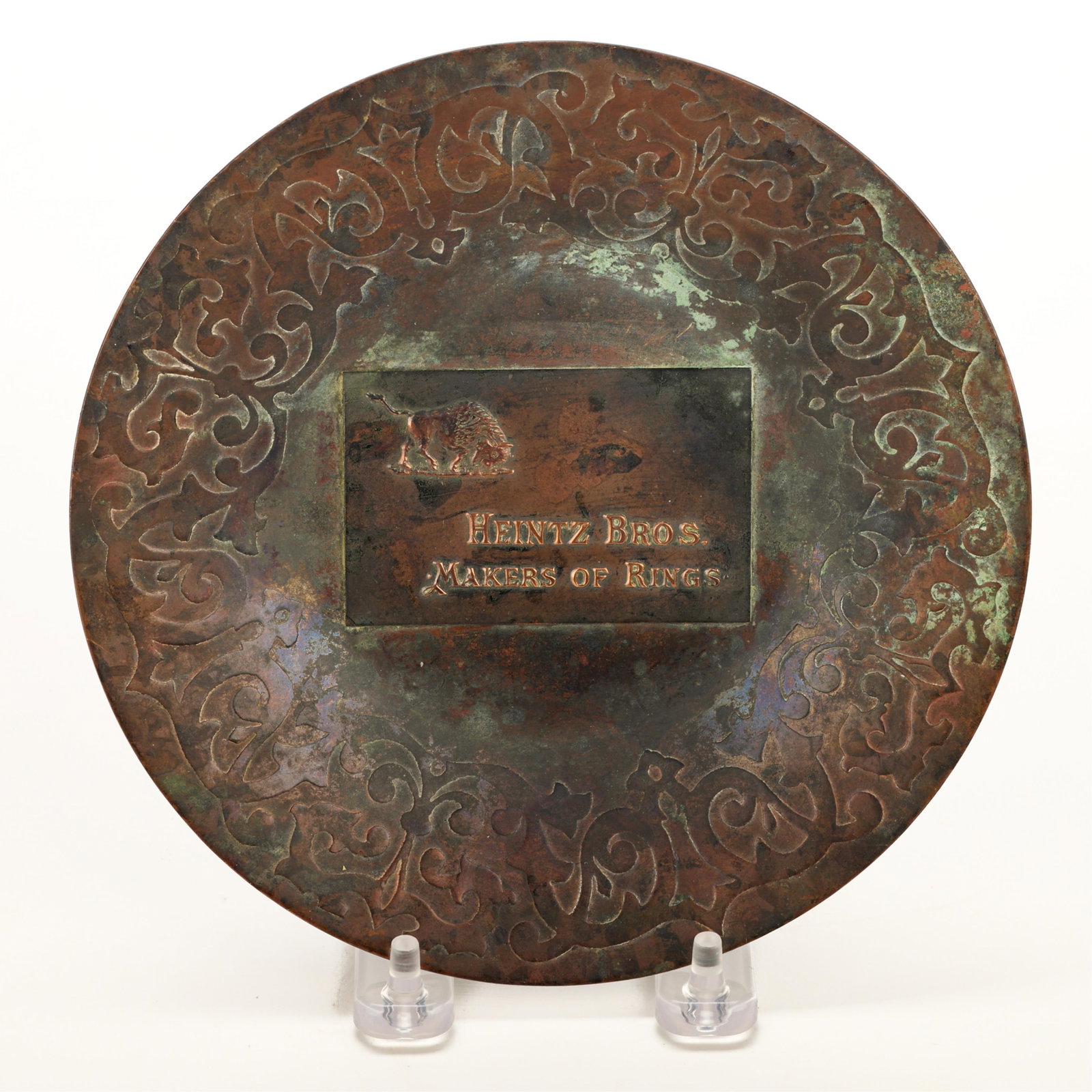 Early Heintz Brothers Bronze "Maker of Rings" Tray: Heintz Brothers, New York, United States. Arts & Crafts bronze metalwork advertising tray or plate, ca. late 19th century. With a plaque along the center reading, "Heintz Bros. Makers of Rings," depic