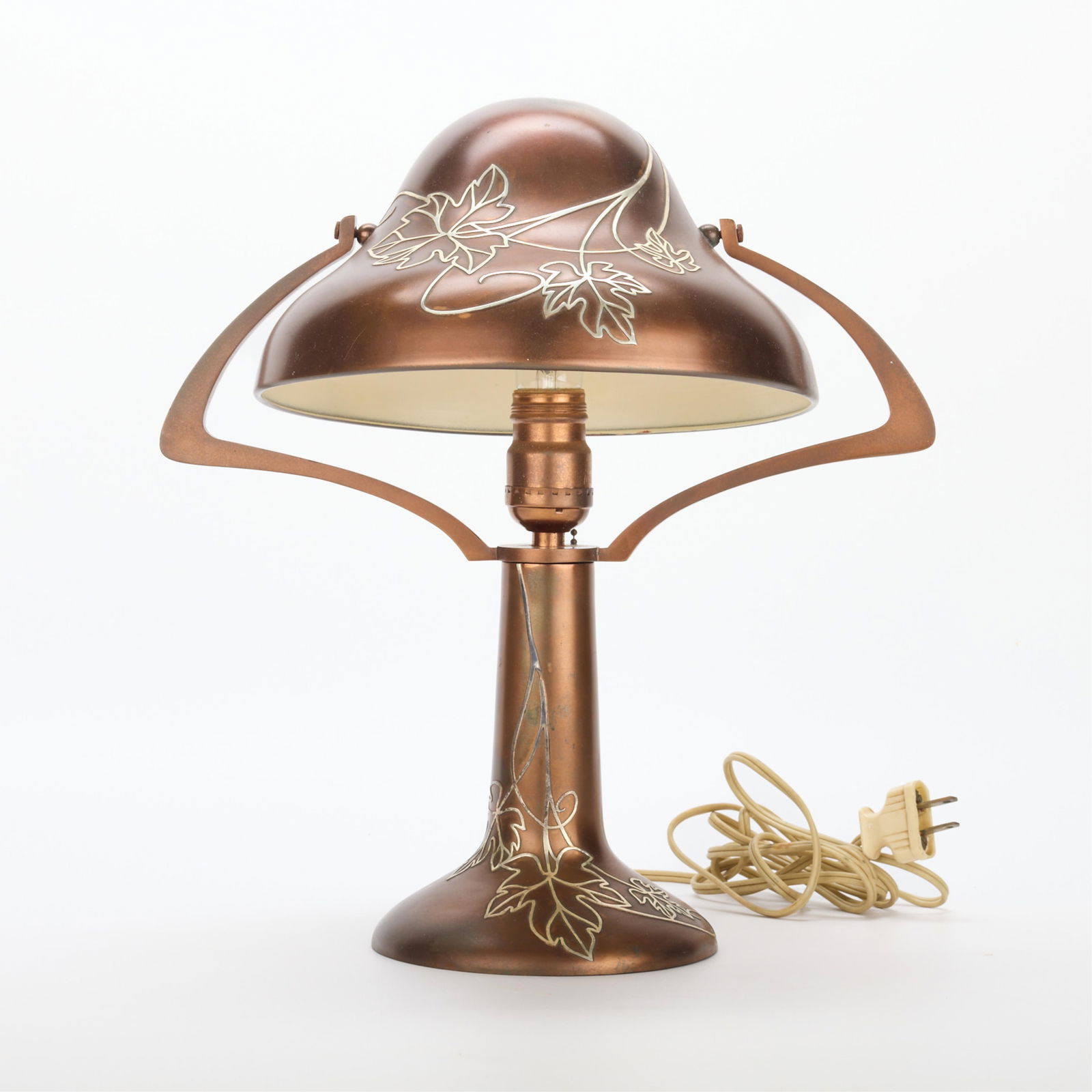 Heintz Arts & Crafts Sterling on Bronze 5504B Lamp: Heintz Art Metal Shop, New York, United States. Arts & Crafts bronze "Bell Helmet" boudoir or table lamp with sterling silver overlay depicting foliate motifs, possibly grape leaves, model no. 5504B,
