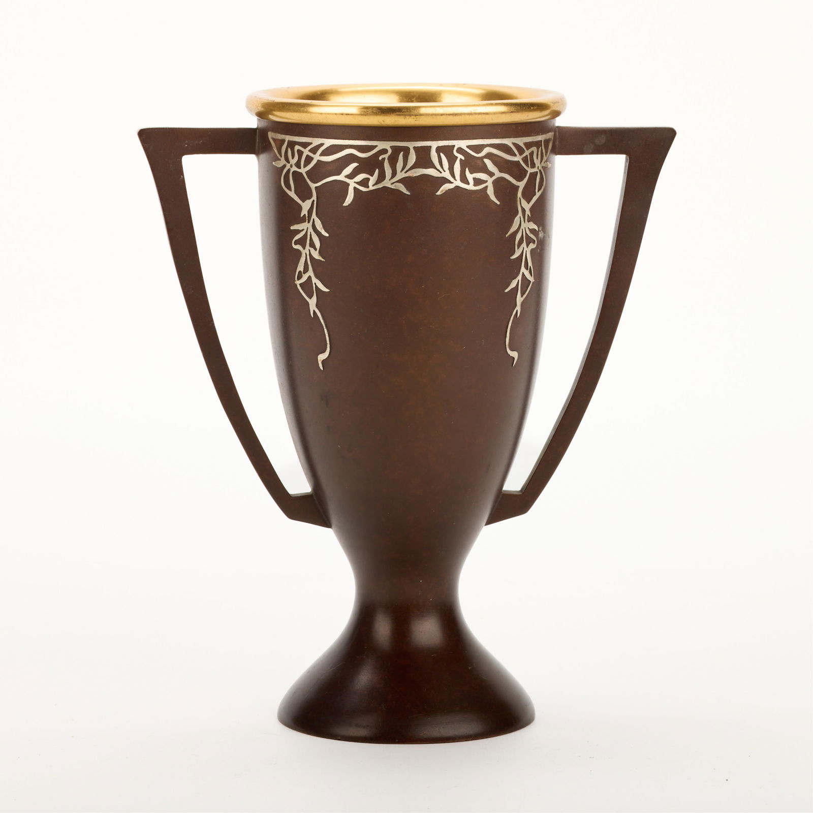 Heintz Arts & Crafts Sterling on Bronze Trophy: Heintz Art Metal Shop, New York, United States. Arts & Crafts bronze loving cup trophy with sterling silver overlay depicting foliate motifs, ca. 1912. Marked and numbered 6550 along the underside.Hei