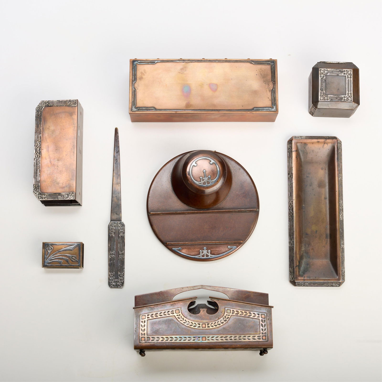 8 Pcs Heintz & Smith Metal Arts Bronze Desk Set: Heintz Art Metal Shop & Smith Metal Arts Company, New York, United States. Arts & Crafts bronze eight-piece desk stationery set, ca. 1912. Including: one square inkwell with glass insert, one letter o