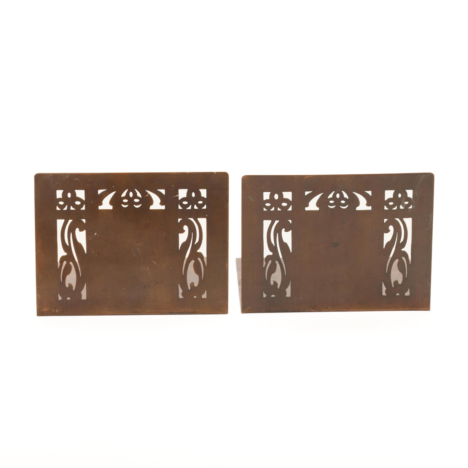 Pr Minneapolis Handicraft Guild Copper Bookends: Handicraft Guild of Minneapolis, Minnesota. Pair of Arts & Crafts handwrought copper bookends, ca. 1900s-1910s. With pierced Art Nouveau motifs. Each stamped.(Each) Height: 4 1/2 in x width: 6 in x de