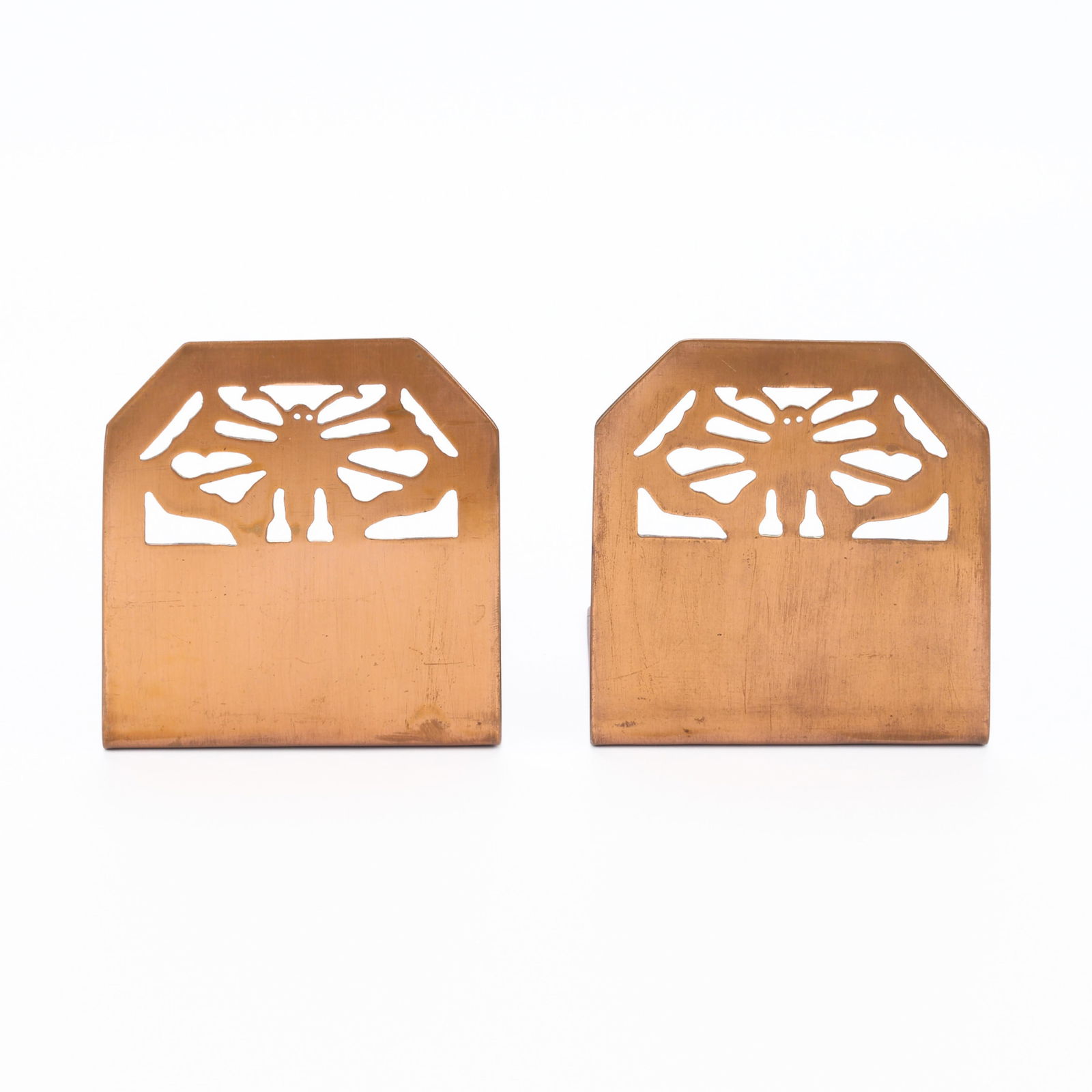 Pr Style of Handicraft Guild Copper Bookends: Style of Handicraft Guild of Minneapolis, Minnesota. Arts & Crafts handwrought copper bookends, ca. 190s-1910s. Depicting pierced butterfly motifs.(Each) Height: 4 3/4 in x width: 4 1/2 in x depth: 4