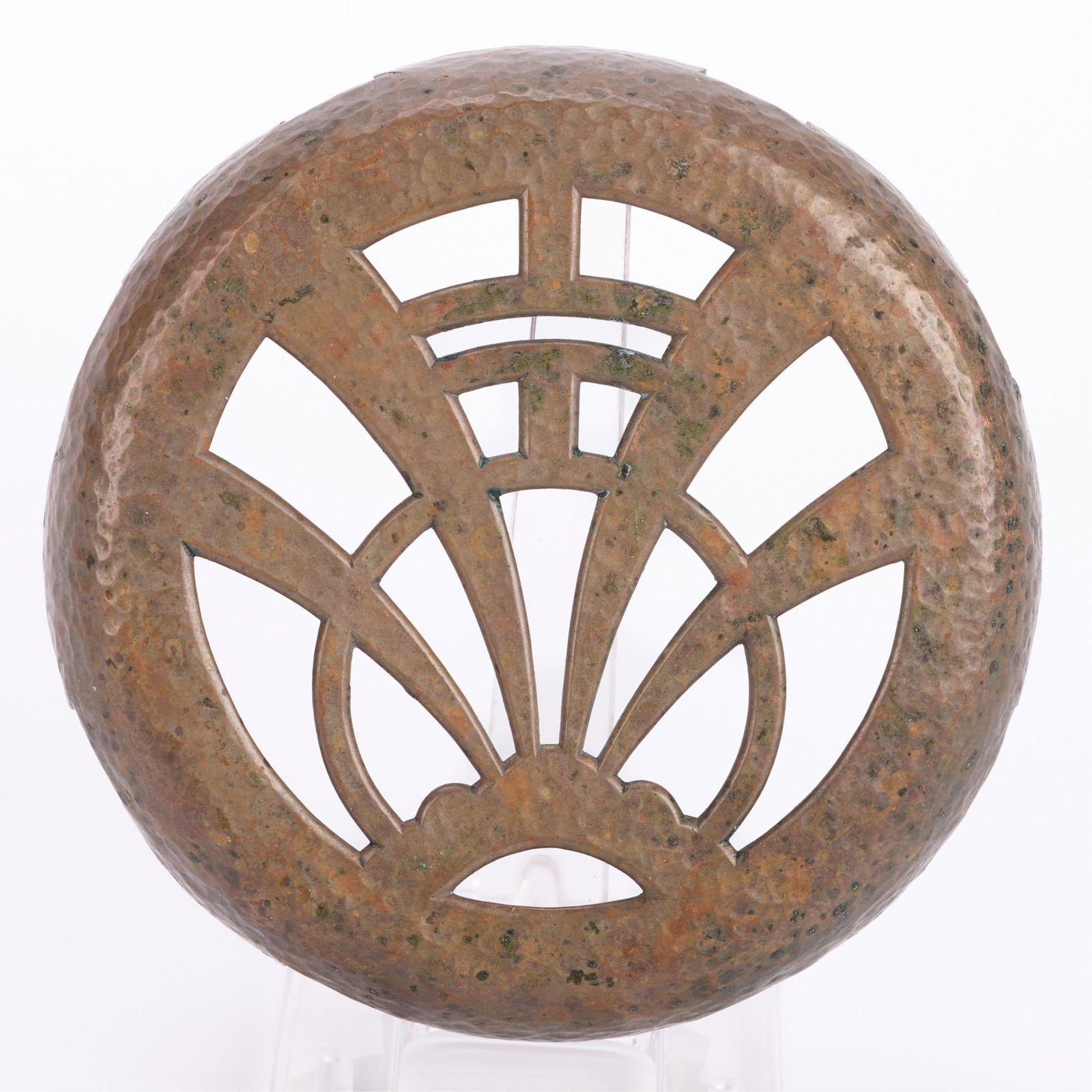 Arts & Crafts Hammered Bronze Pierced Trivet: Arts & Crafts-style hammered bronze metalwork trivet with pierced geometric motifs.Height: 1 in x diameter: 6 in.