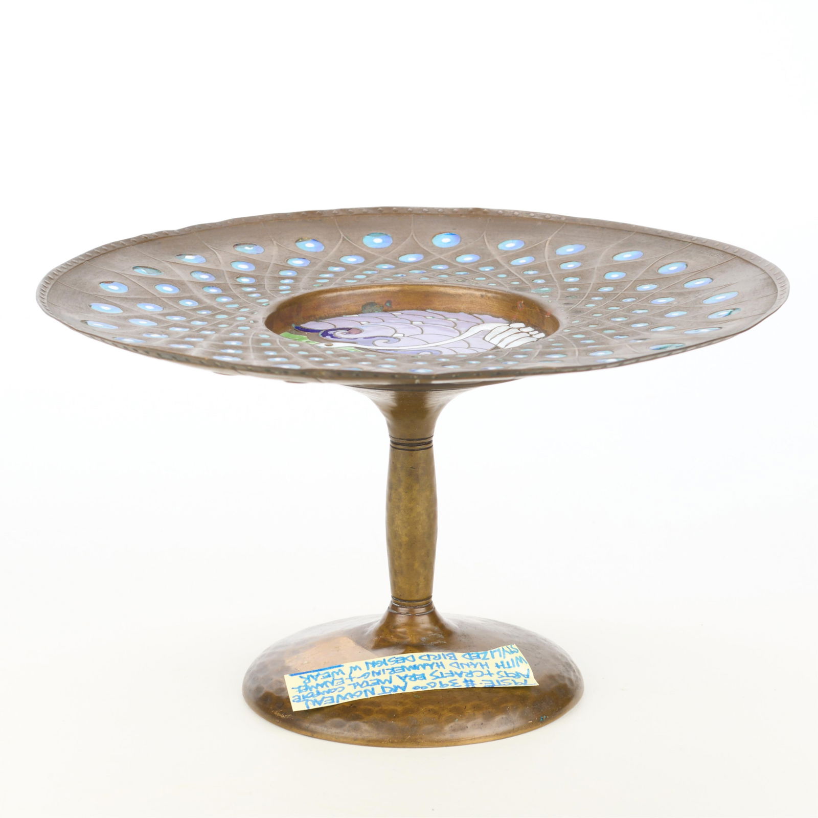 Arts & Crafts Hammered Copper & Enamel Compote: Arts & Crafts hammered copper pedestal dish or compote. With a central Art Nouveau-style enameled bird, possibly depicting a crane or swan, and decorative dotted border.Height: 4 1/2 in x diameter: 8