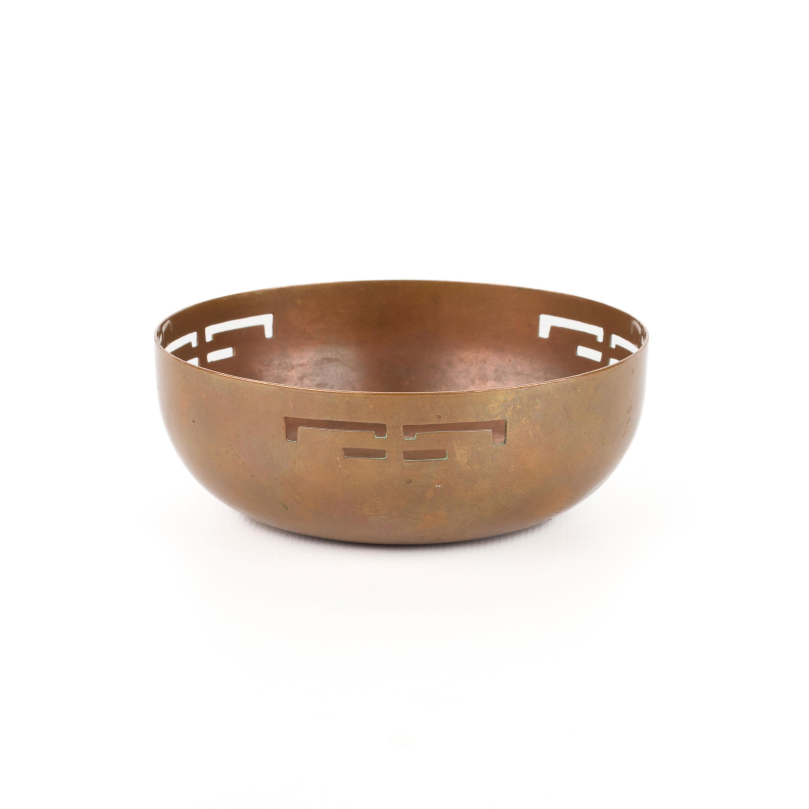 Minneapolis Handicraft Guild Pierced Copper Bowl: Handicraft Guild of Minneapolis, Minnesota. Arts & Crafts handwrought copper bowl with pierced geometric motif along the rim, ca. 1900s-1910s. Marked along the underside.Height: 1 1/2 in x diameter: 4