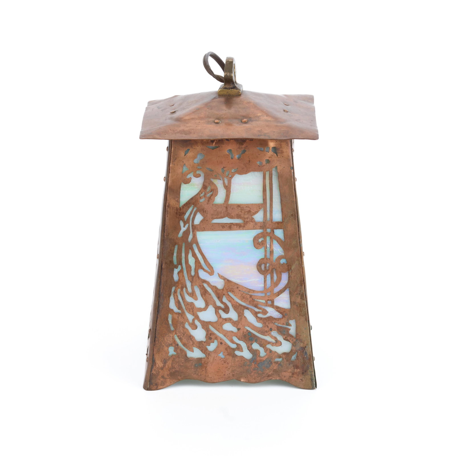 Handicraft Guild Pierced Copper Peacock Lantern: Handicraft Guild of Minneapolis, Minnesota. Arts & Crafts handwrought copper lantern, ca. 1900s-1910s. Depicting elaborate pierced peacock motifs along each side. With iridescent stained slag glass pa