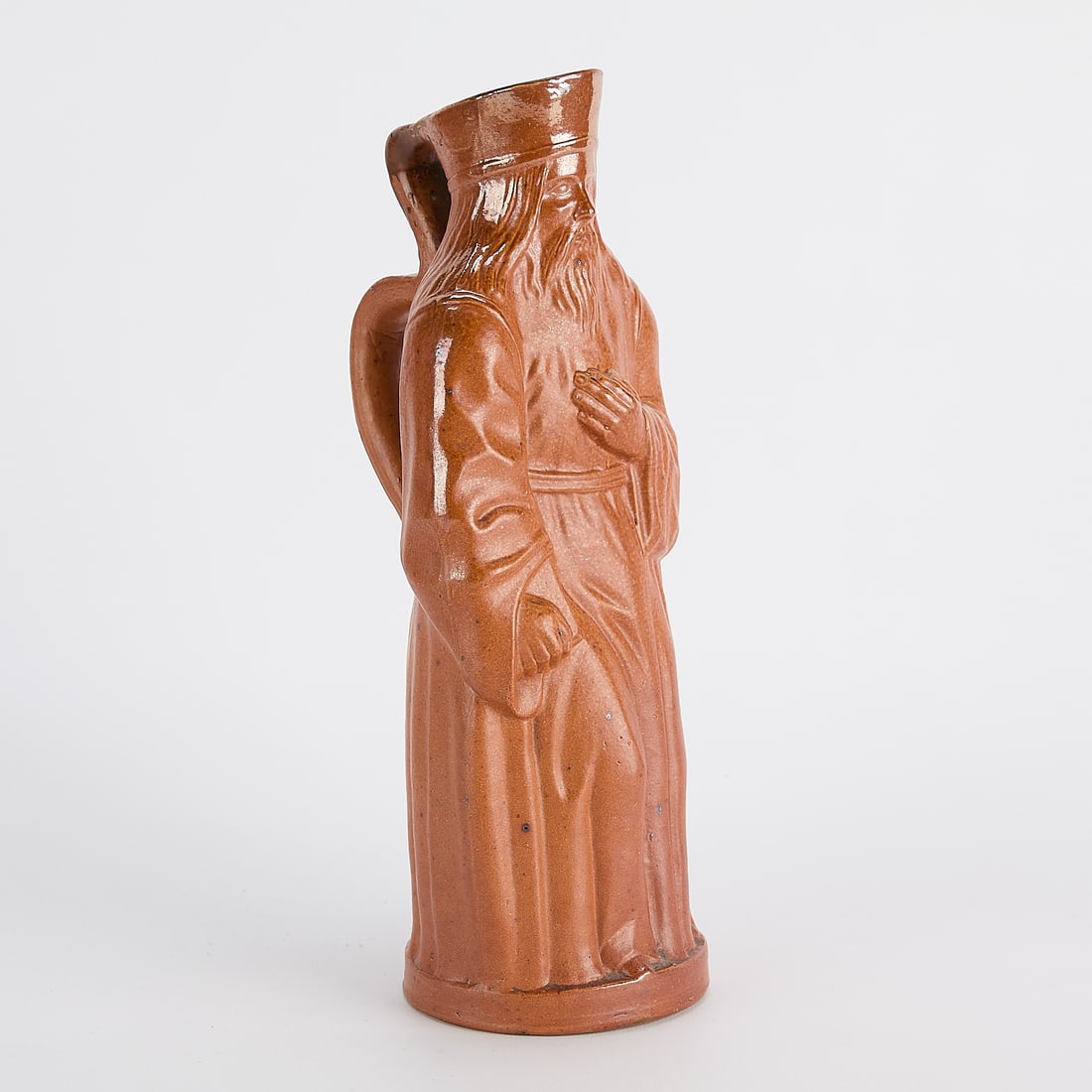 Royal Doulton Lambeth Pottery Toby "Priest" Jug: Royal Doulton, Lambeth, England. Arts & Crafts figural pottery toby jug titled "The Priest" depicting the titular figure clutching a bible, ca. 1900. Salt-glazed stoneware. For a similar example,