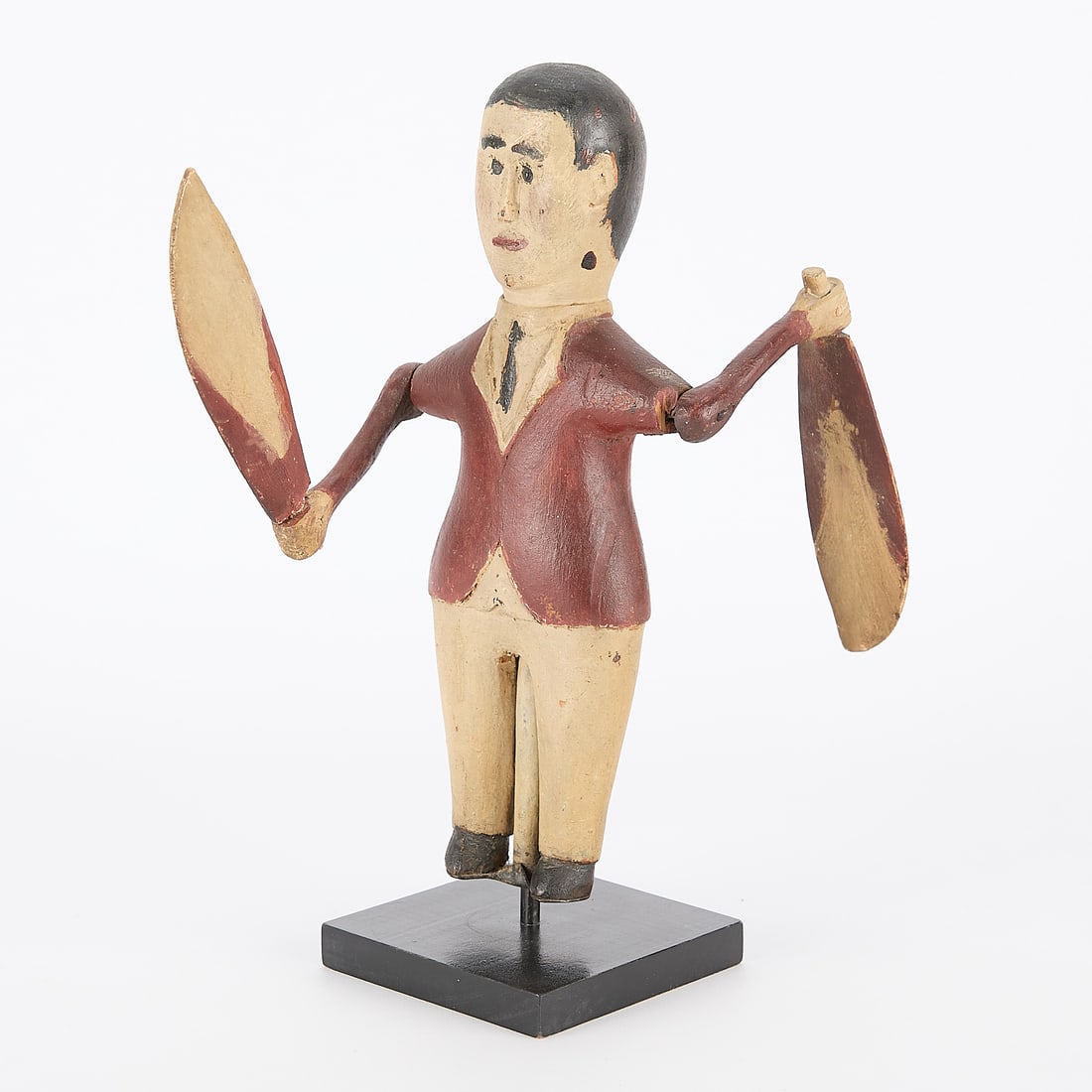 Early 20th c. Folk Art Wooden Whirligig Figure: Early 20th century folk art carved and painted wooden whirligig. Depicting a "dancing man" or "dancing jig" figure. With custom wooden stand. Height: 10 in x width: 4 1/2 in x depth: 7 1/2 in.