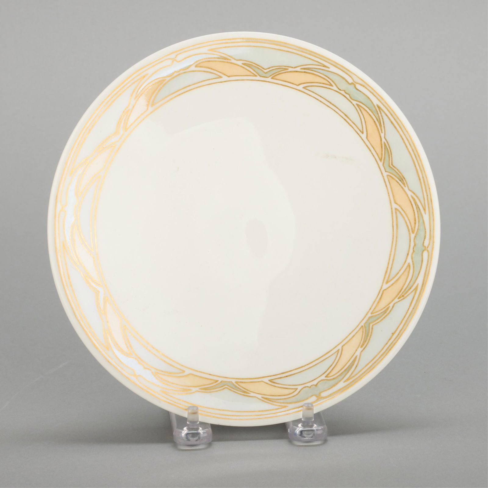 Hilma Berglund Art Nouveau Gilt Porcelain Plate: Hilma Berglund (American, 1886-1972). Art Nouveau porcelain plate, depicting gilt geometric motifs along the rim. Stamped along the underside. Diameter: 7 3/4 in.