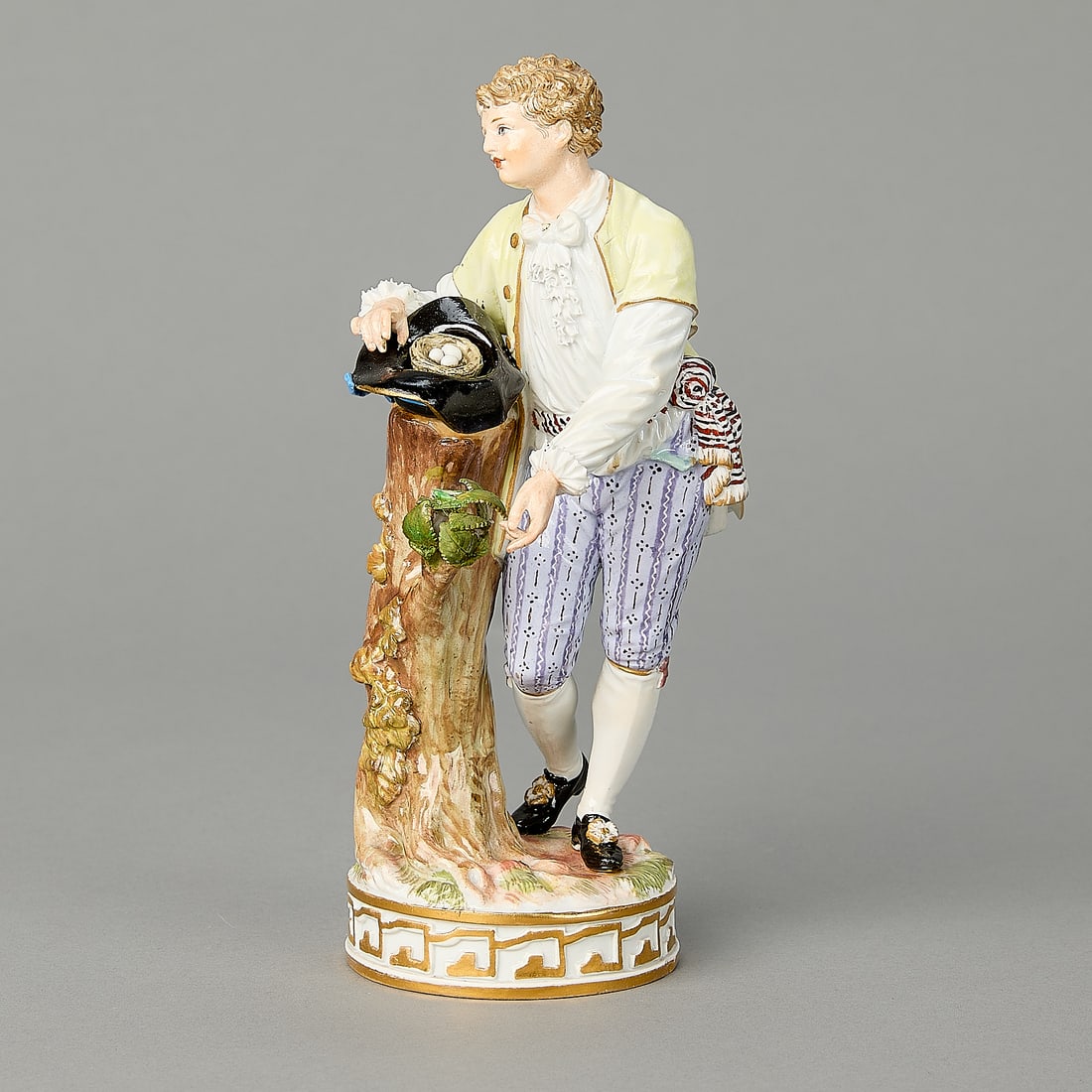 Meissen Figure of Farm Boy ca.1860: Meissen, Germany. Porcelain figure of a farm boy, ca. 1860. Modelled standing next to a tree stump gathering a nest of bird's eggs in his hat. Provenance: The Distinguished Collection of Leo & Doris H