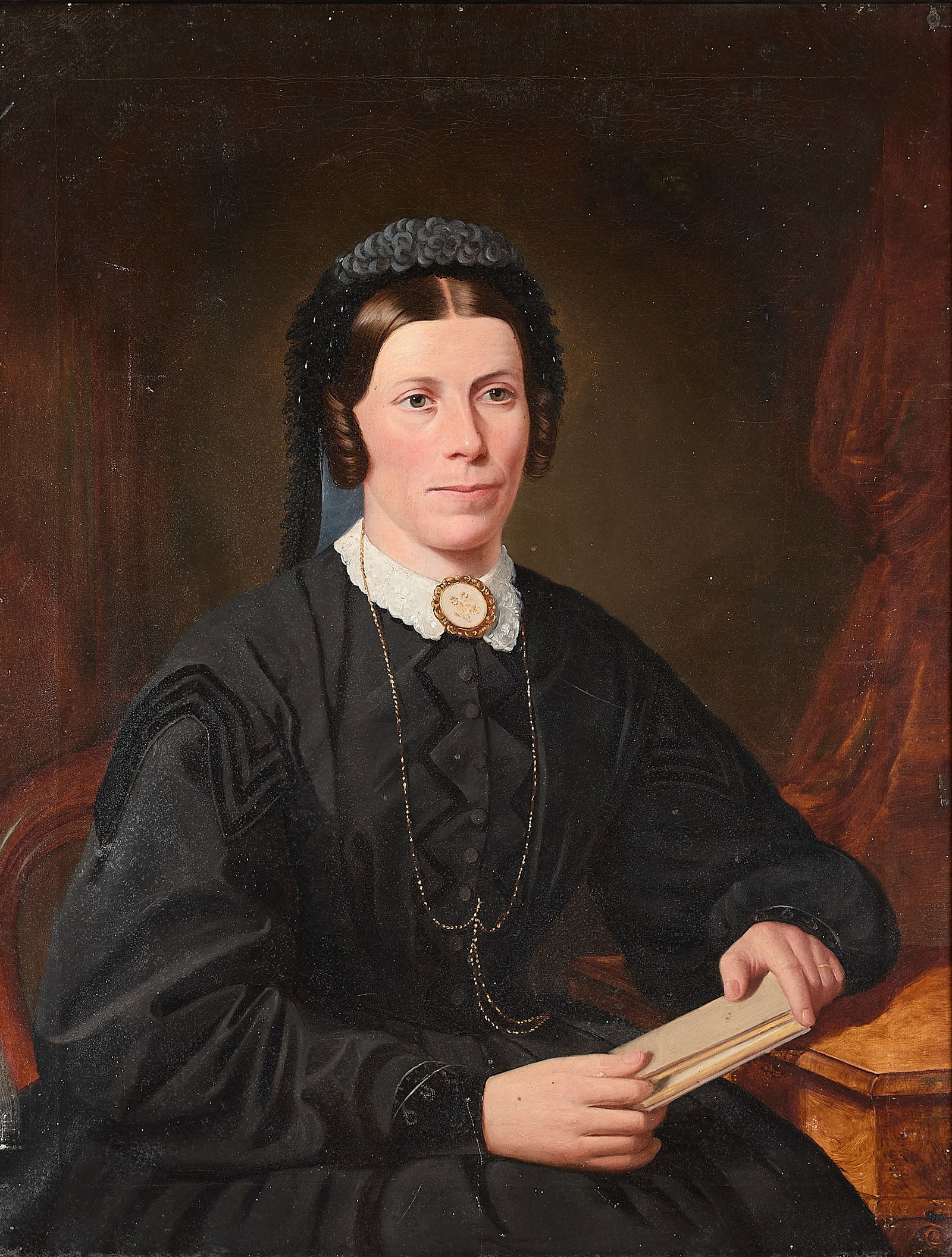 19th c. American School Portrait of a Woman: American school oil on canvas portrait painting depicting a woman in three-quarters view. She wears a sumptuous black gown trimmed with crushed black velvet. An ornate gold floral brooch is clasped at
