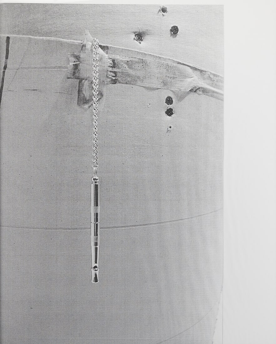 Large Print of Whistle: Print on paper depicting a whistle dangling from a chain affixed to a structure with screws. Sight; height: 44 in x width: 36 in. Framed; height: 45 3/4 in x width: 37 1/4 in x depth: 2 in.