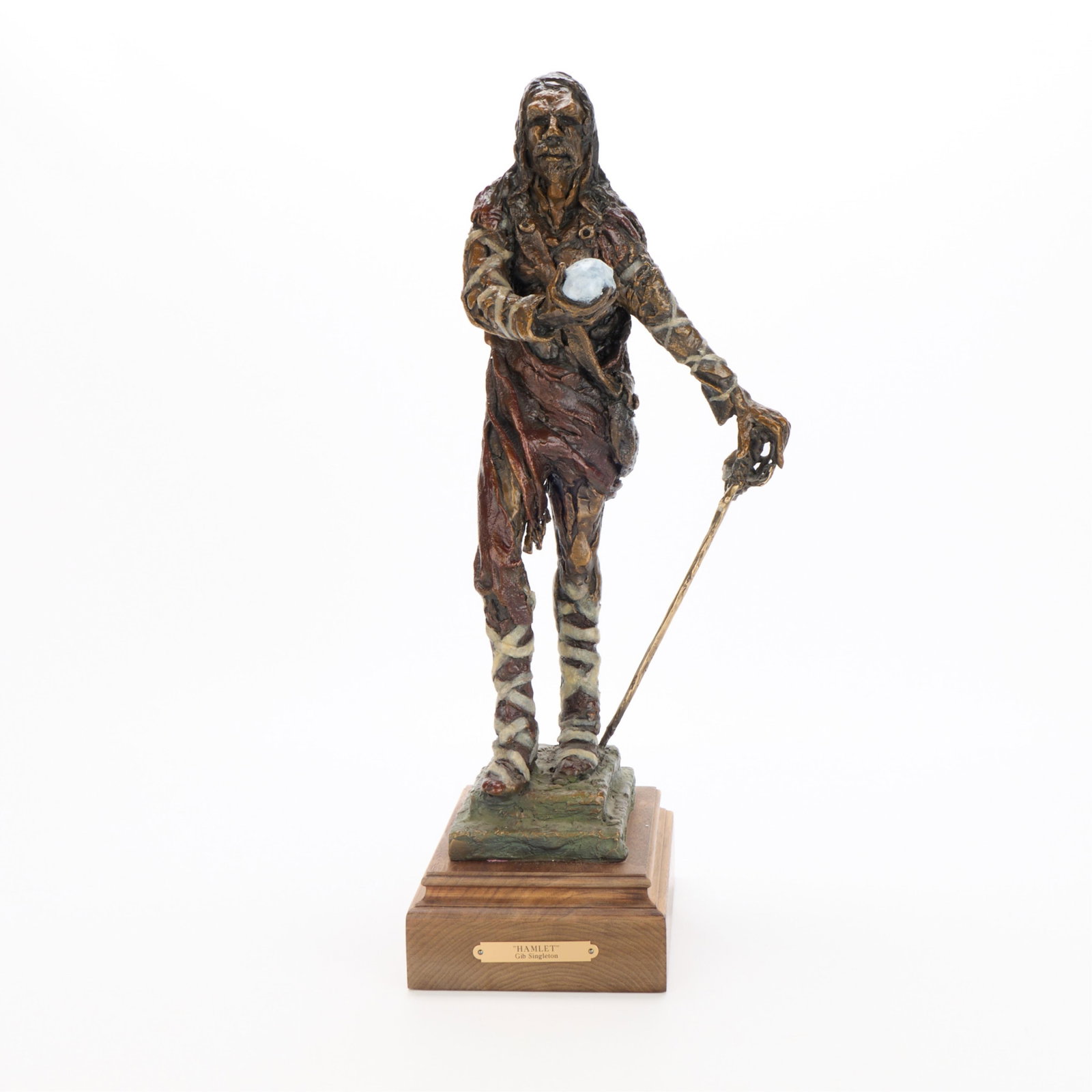 Gib Singleton "Hamlet" Bronze Sculpture: Gilbert Jerome "Gib" Singleton (American, 1935-2014). Bronze sculpture titled "Hamlet." Depicting the iconic Shakespearean character holding a skull in his right hand. Incised signature along the lowe