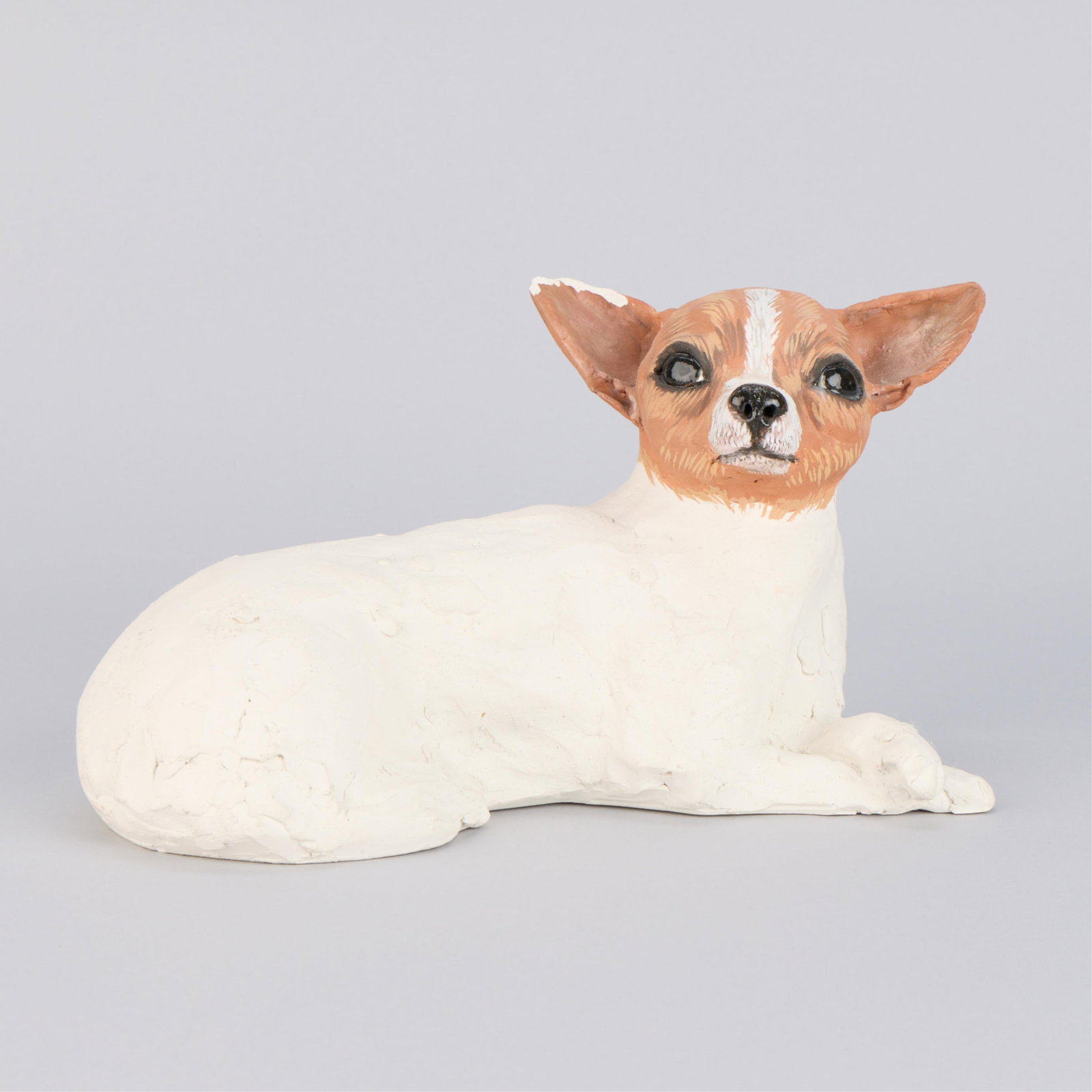 Cheryl Laemmle Ceramic "Tipo" Dog Sculpture 1997: Cheryl Laemmle (American, b. 1947). Studio ceramic sculpture titled "Tipo," 1997. Earthenware with pigment. Depicting a recumbent chihuahua dog. Signed and dated along the underside. Provenance: Allen