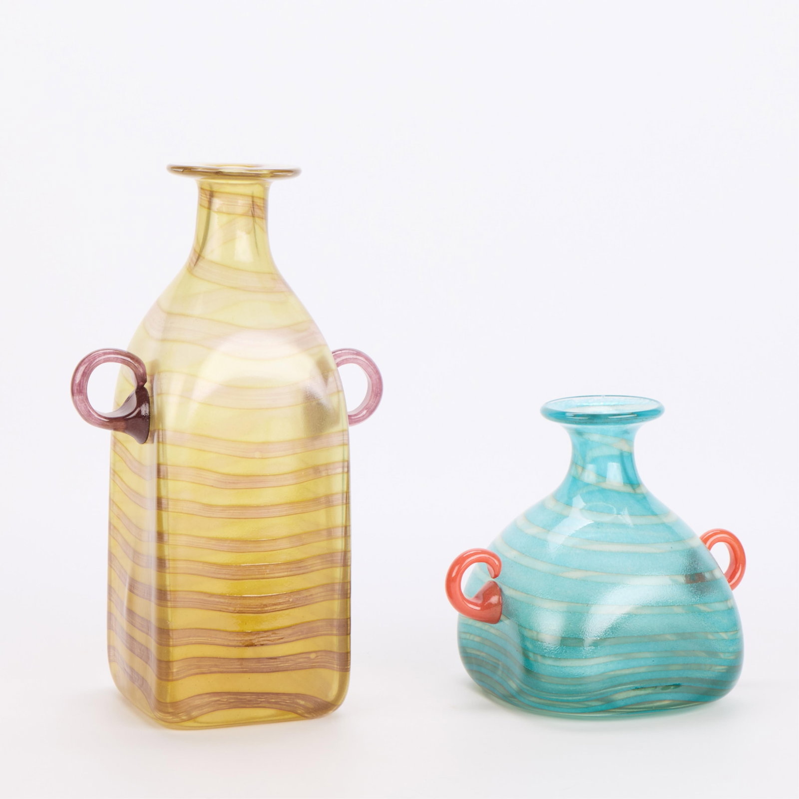 2 Marco Zetti Murano Art Glass Striped Vases: Marco Zetti (Italian, 20th century). Group of two Murano art glass vases with colorful striped canes and double loop handles. Etched signature along the underside of each. (Yellow vase) Height: 12 3/4