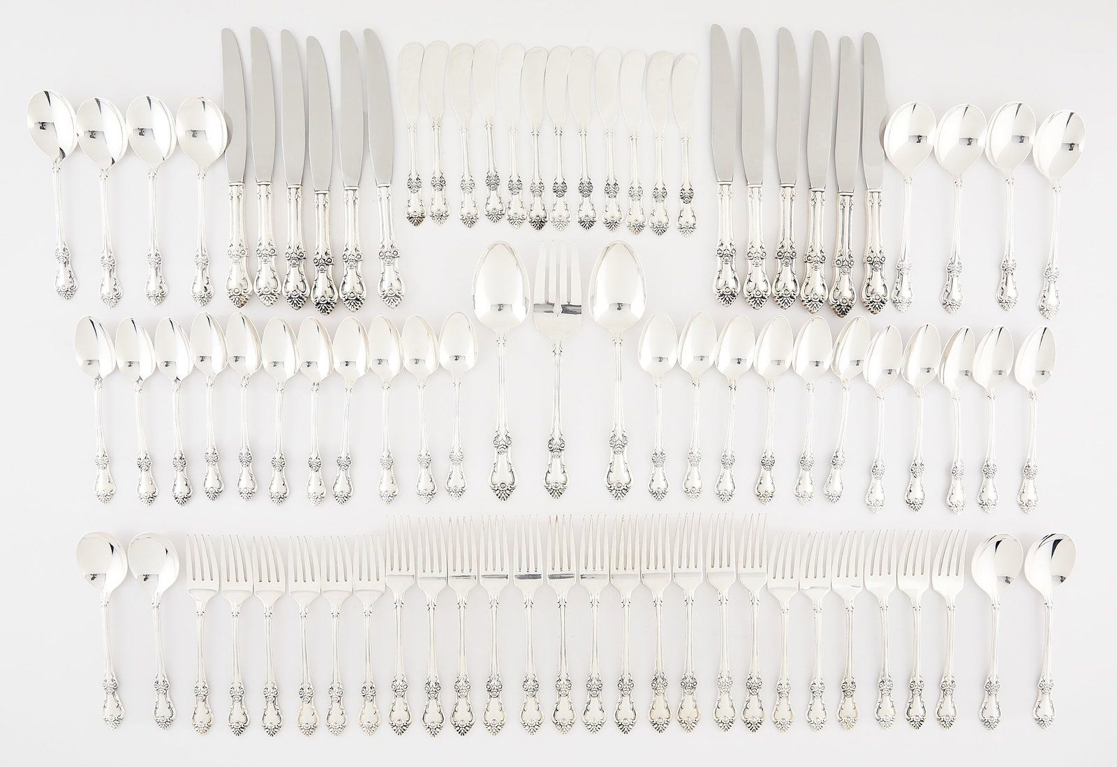 75 Pc Oneida Sterling Afterglow Flatware 111.2 ozt: Oneida, United States. Set of 75-pieces of sterling silver "Afterglow" patterned flatware, 20th century. Each piece depicting repousse floral motifs. Including: one serving fork, two serving spoons, t