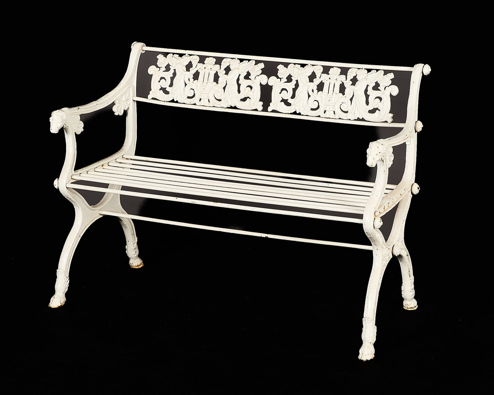 19th c. Karl Friedrich Schinkel Cast-Iron Bench: Karl Friedrich Schinkel (Prussian, 1761-1841). White-painted cast-iron garden settee or child's bench, 19th century. The pierced splat depicting a cast scene with winged putti and scrolling foliate fo