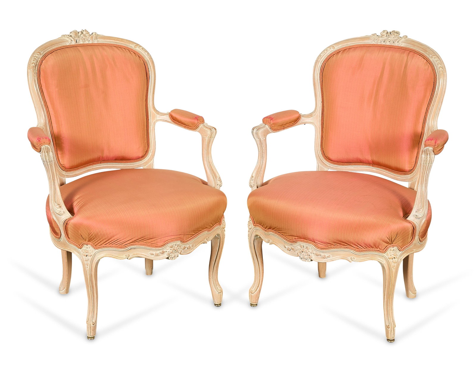 Pr French Louis XV Wooden Fauteuil Armchairs: Pair of French Louis XV wooden fauteuils or armchairs. Each featuring a shield-shaped back with scrolling open arms, a cream-painted frame with carved floral motifs, striped coral upholstery, and cabr