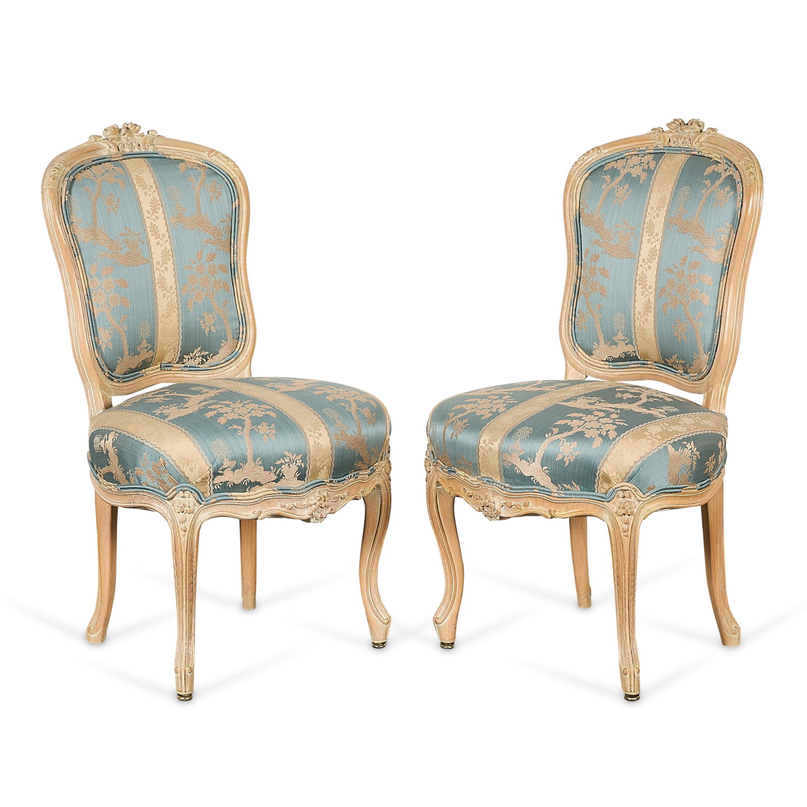 Pr French Regence Provincial Beechwood Chairs: Pair of French Regence provincial limed beechwood dining chairs or side chaises, 18th century. Each with a shield-shaped back surmounted by carved floral cresting, blue and cream upholstery featuring 