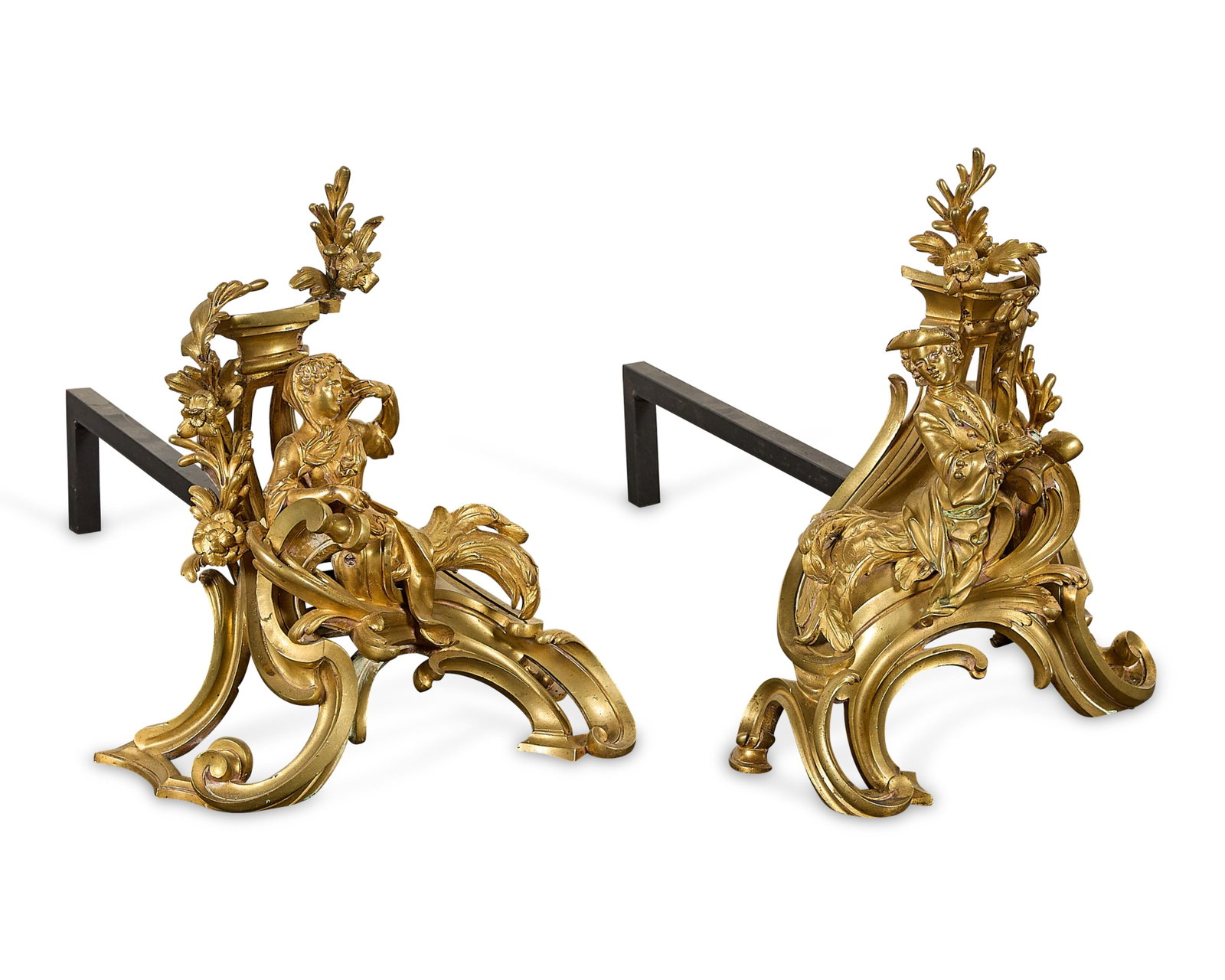 Pr French Louis XV Gilt Bronze Figural Chenets: Style of Jacques Caffieri (French, 1678-1755). Pair of French Louis XV ormolu chenets, andirons, or firedogs, 18th century. With figural mounts atop Rocaille or Rococo scrollwork bases adorned with fo