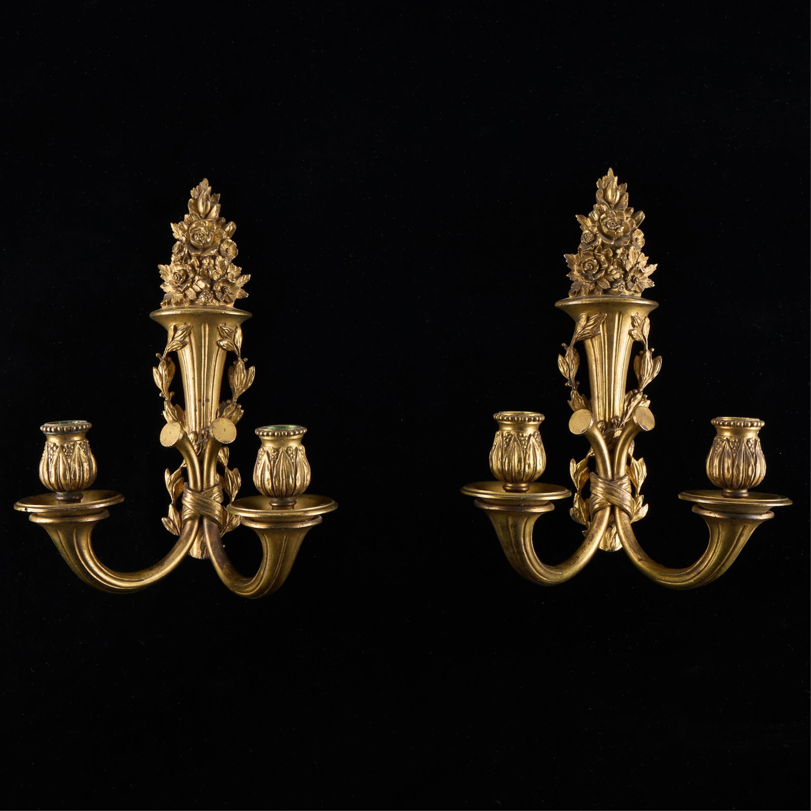 Pr Louis XV Ormolu Foliate Wall Sconces: Pair of French Louis XV-style gilt bronze two-branch wall sconces featuring molded foliate motifs, 19th century. Provenance: The Distinguished Collection of Leo & Doris Hodroff. (Each) height: 12 in x