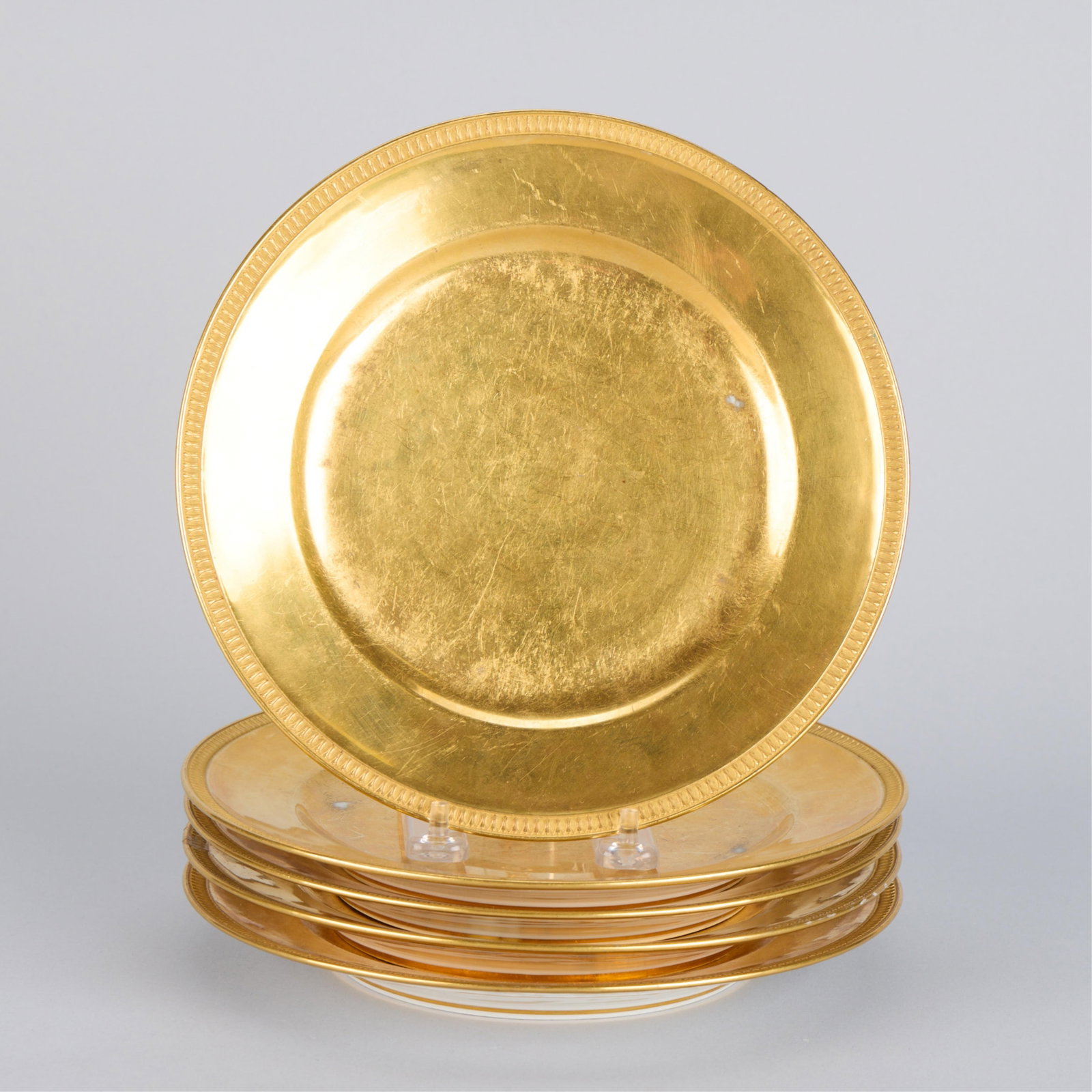 5 French Paris Nast Gilt Porcelain Dessert Plates: Manufacture de Nast, France. Set of five gilt porcelain dessert plates, 19th century. Inscribed in gilt "Nast a Paris par brevet d'invention (Nast in Paris by patent of invention)" along the underside