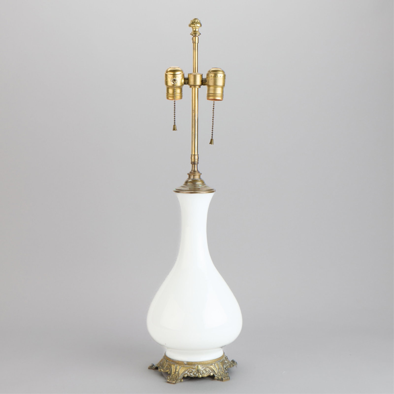 Style Bristol Glass White Opaline Vase Table Lamp: Style of Bristol Glass, United Kingdom. White opaline glass vase mounted as a table lamp. With gilt bronze mounts and scrollwork base. Provenance: The Distinguished Collection of Leo & Doris Hodroff. 