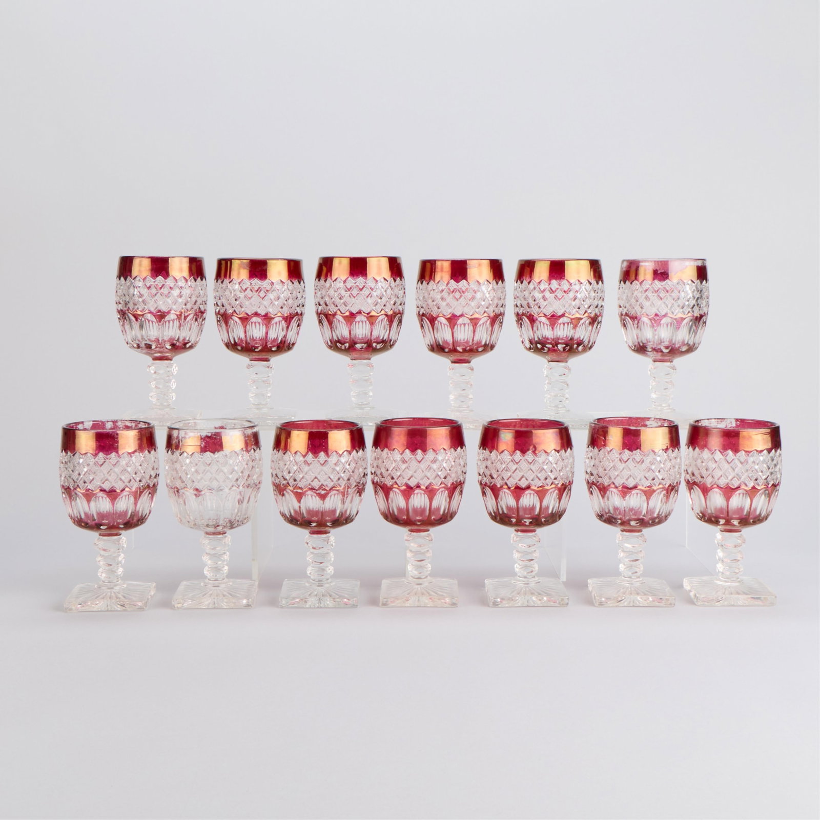 13 Westmoreland "Wakefield" Red Ruby Flash Goblets: Westmoreland Glass Company, United States. Set of 13 cut glass goblets in pattern "Wakefield," otherwise known as "Waterford." Each featuring a red "Ruby Flash" stain with diamond cut and thumbprint d