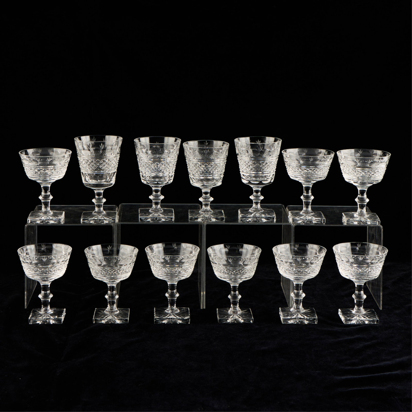 13 Edinburgh Scottish Cut Crystal Goblets: Group of thirteen Scottish cut crystal glass goblets with square-form bases. Eleven with incised mark along the underside "Made in Edinburgh Scotland." Two unmarked. Provenance: The Distinguished Coll