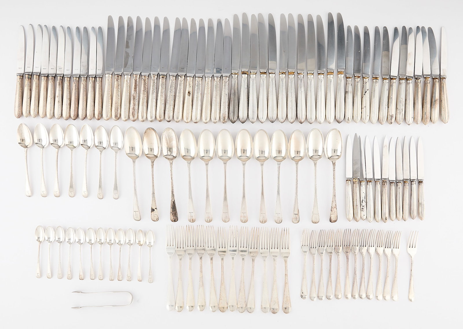 117 Pcs English Sterling Flatware - 86.42 ozt: Large group of 117 pieces of Georgian English sterling silver flatware, 18-19th century. Each piece with incised and bright-cut linear "threaded" or beaded motifs along the handles. The spoons of Old 