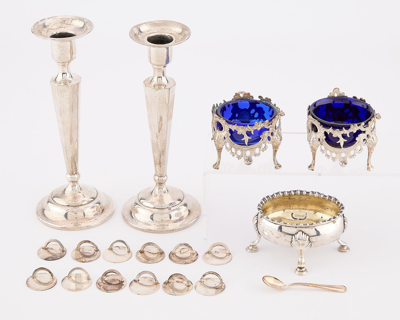 18 Pcs Misc. Sterling Silver Objects: Group of 18 miscellaneous sterling silver table objects. Including: Two English George III sterling salt cellars with swag design and cobalt blue glass interiors. Marked for Birmingham assay and sterl