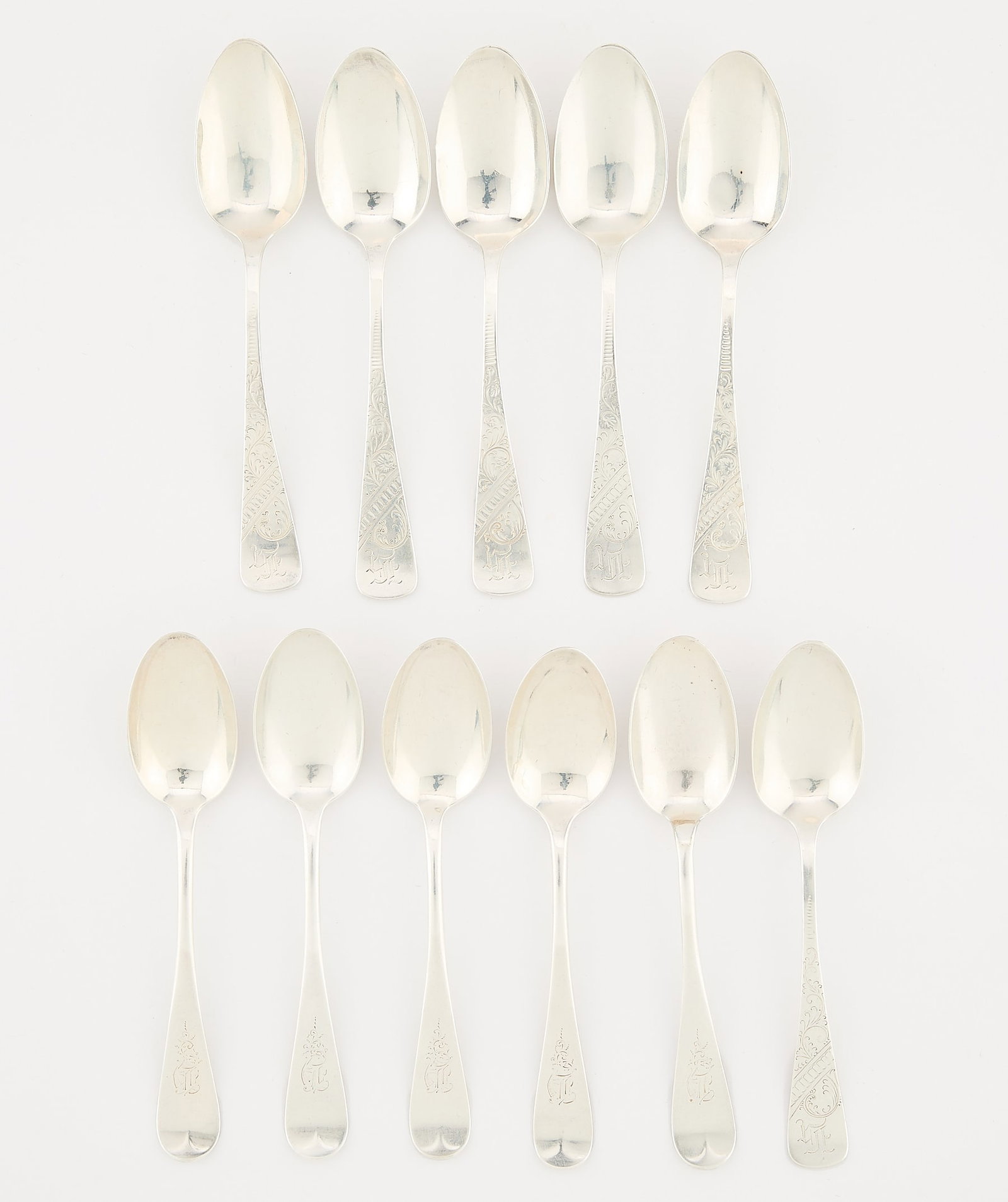 11 Towle Sterling Silver Spoons 8.025 ozt: Towle Silversmiths, United States. Group of 11 sterling silver spoons. Including six spoons with engraved floral patterns and five spoons with modest stems. Each spoon monogrammed variously. With impr