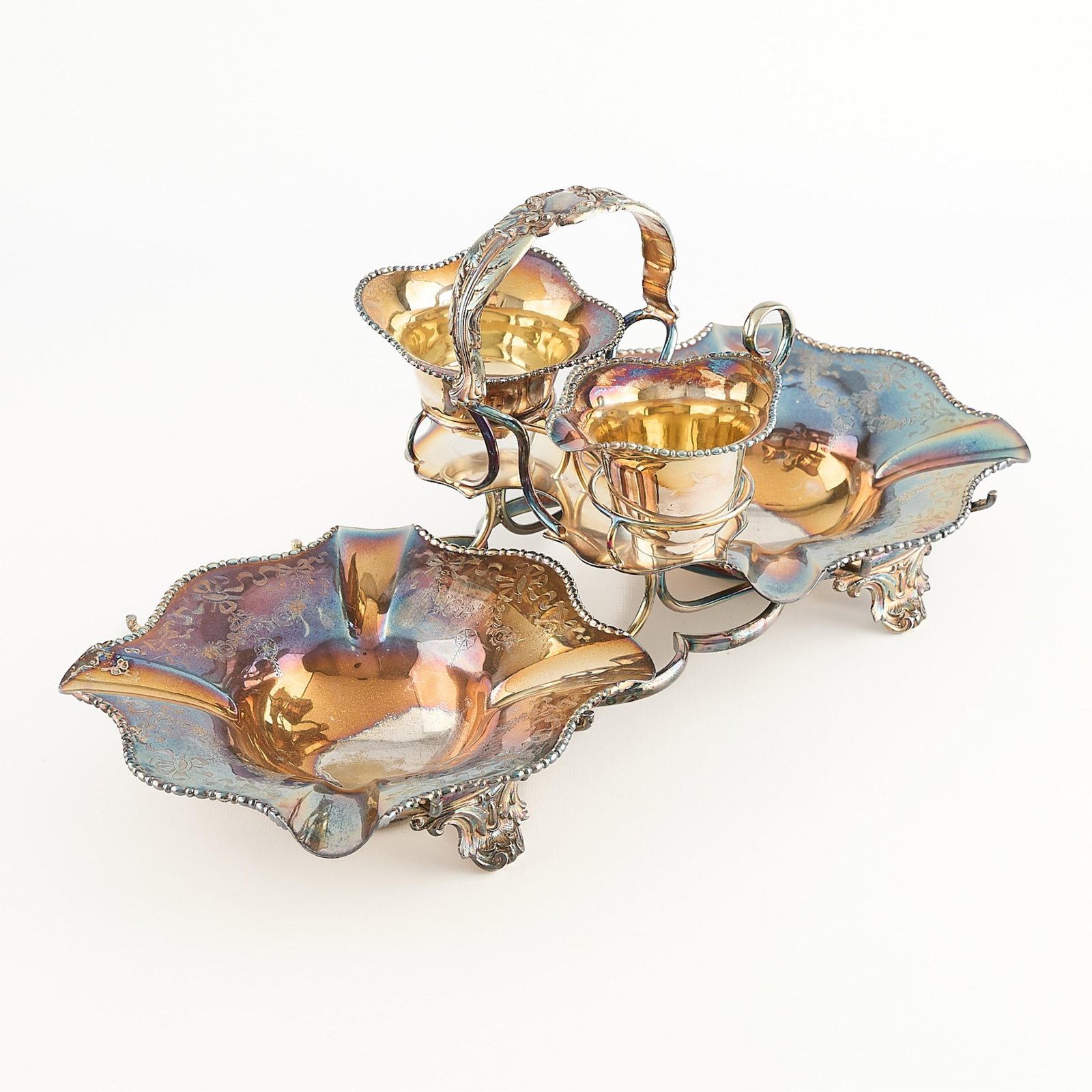 Walker & Hall Sheffield Silverplate Condiment Set: Walker & Hall, Sheffield. Victorian English silver plate condiment server vessel, 20th century. Comprising two larger bowls, a smaller bowl, and one pitcher. Each piece of undulating form resting with