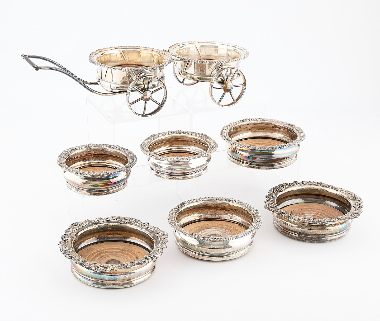 7 M.F. & Co. Silverplate Wine Wagons & Coasters: Matthew Fenton & Co., Sheffield. Group of seven pieces of English silver plate wine-serving objects. Including one silver-plated wine wagon, mounted with two inset large coasters, and three additional