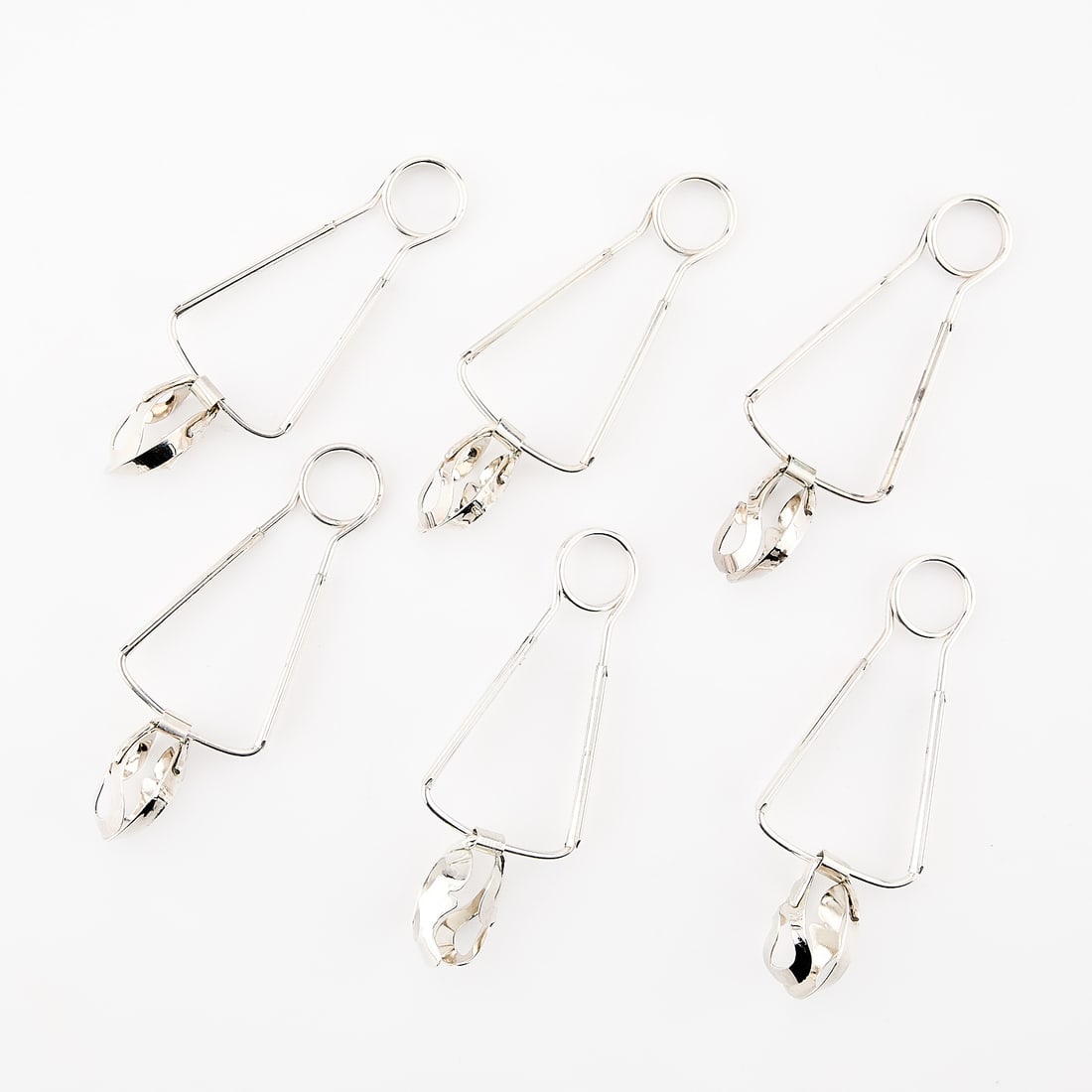 6 French Stainless Steel Escargot Tongs: Set of six stainless steel French escargot tongs. Marked "Metal Blanc" along the base of the handle. Provenance: The Distinguished Collection of Leo & Doris Hodroff. (Each) Length: 6 in x width: 2 1/2