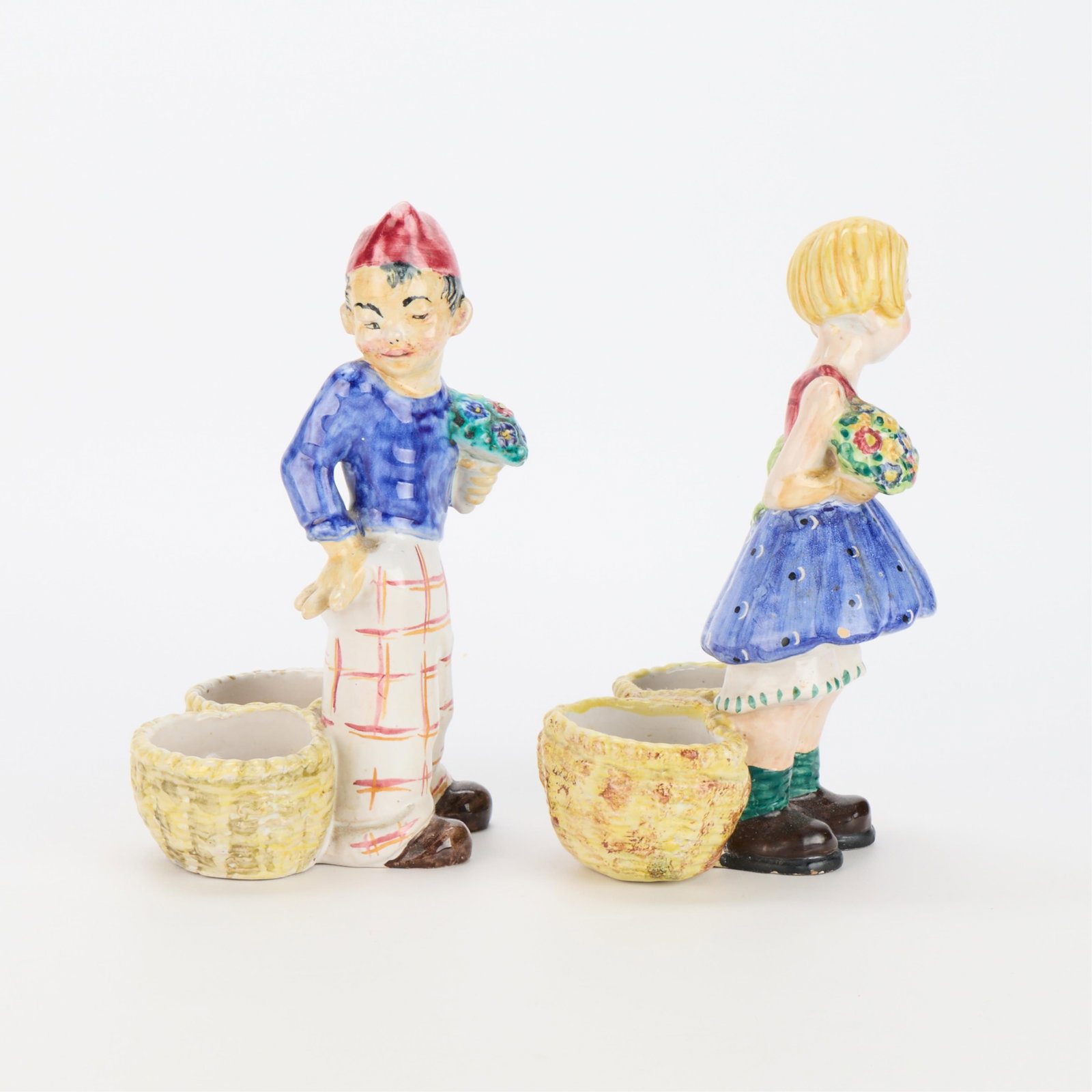 2 Italian Ceramic Figural Statuette Planters: Group of two Italian ceramic planters in the form of statuettes, 20th century. Including one boy and one girl figurine, each with double baskets behind their feet. Each ink inscribed "Beta Perugia Ita