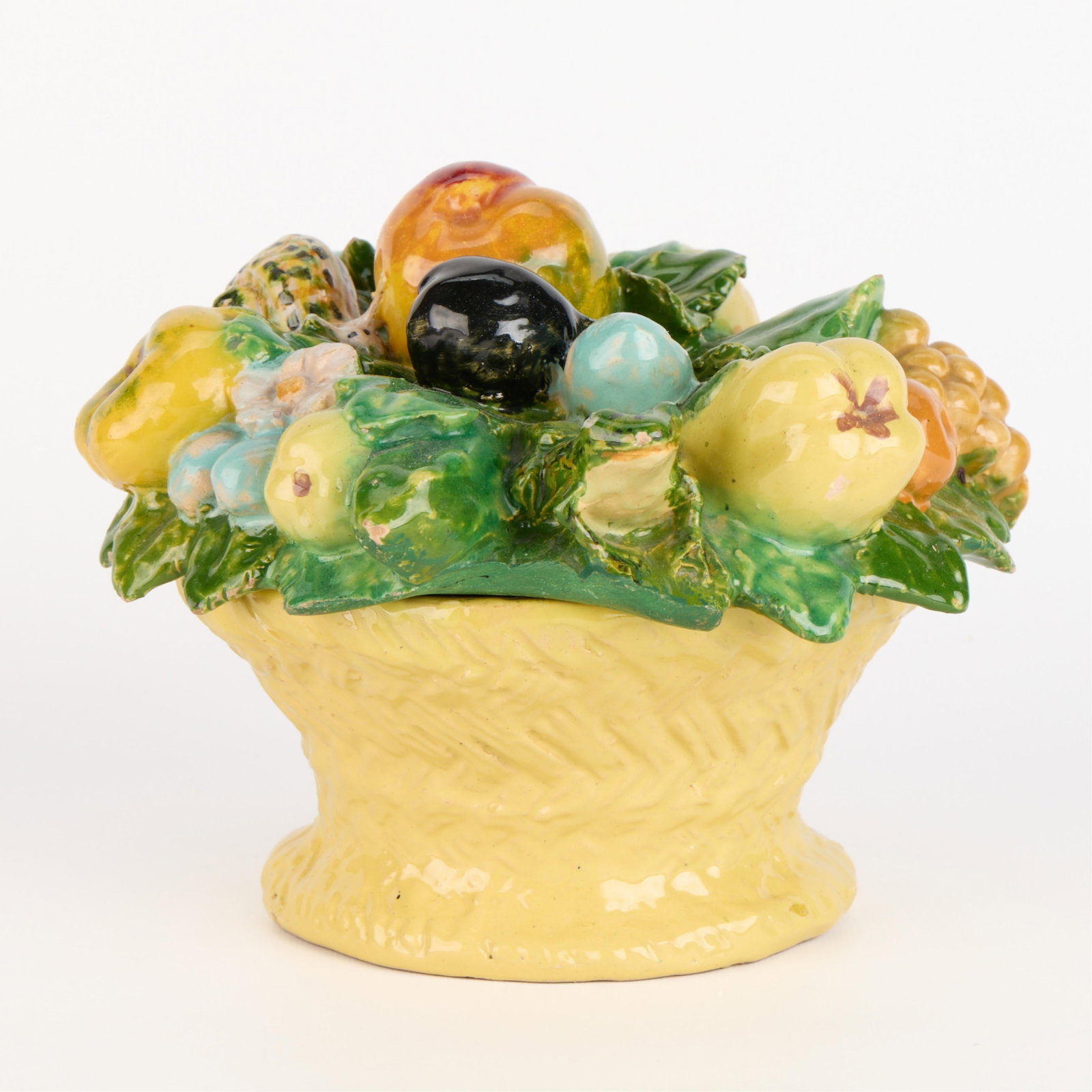 Italian Majolica Pottery Covered Fruit Bowl: Italian Majolica ceramic bowl with a molded lid featuring a variety of ripe fruit and a snail. Provenance: The Distinguished Collection of Leo & Doris Hodroff. Height: 7 1/4 in x diameter: 9 in.
