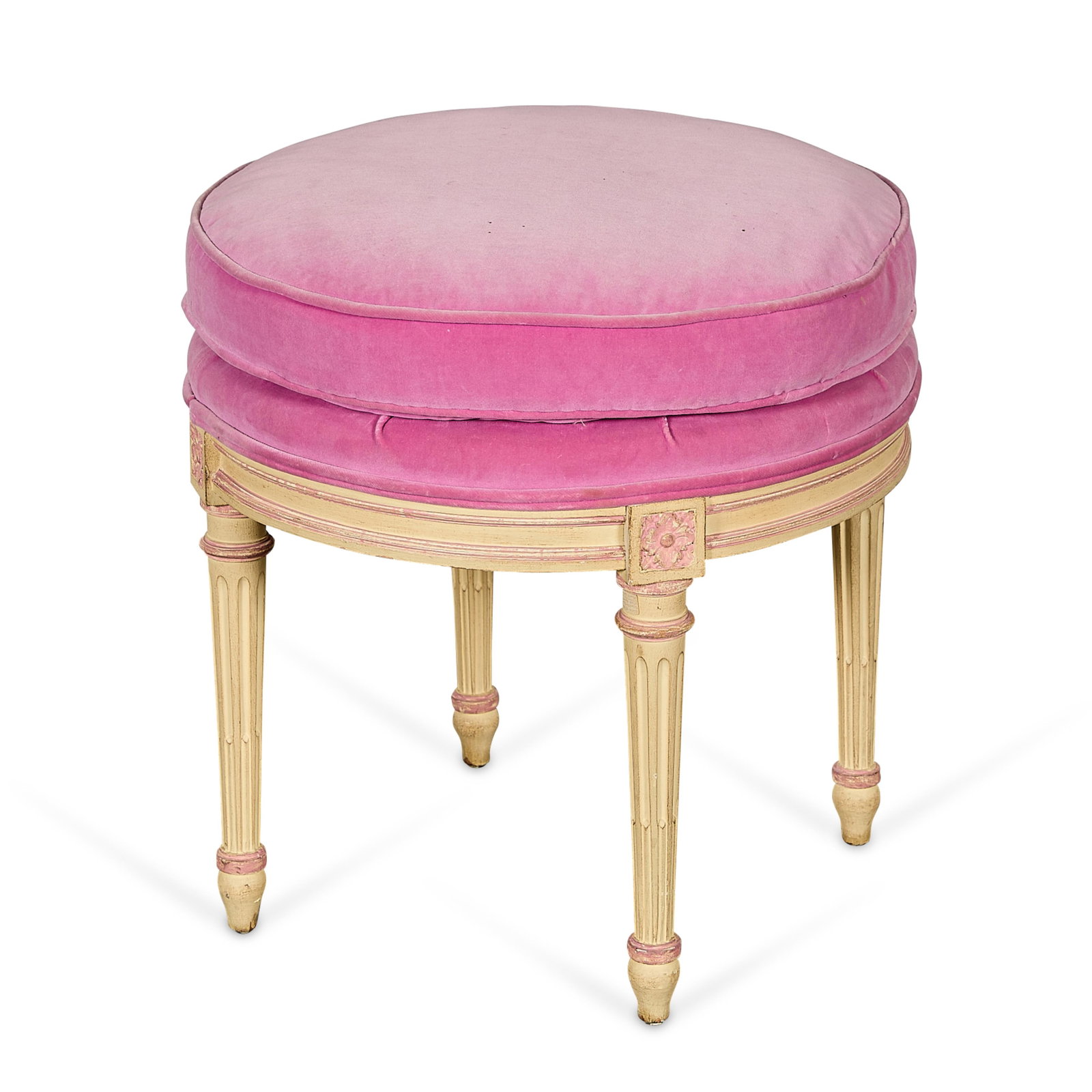 Louis XVI Style Pink Velvet Upholstered Ottoman: Louis XVI-style stool or ottoman featuring a pink velvet upholstered seat atop four fluted and tapered legs decorated with carved rosettes. Cream and pink polychrome frame. Provenance: The Distinguish