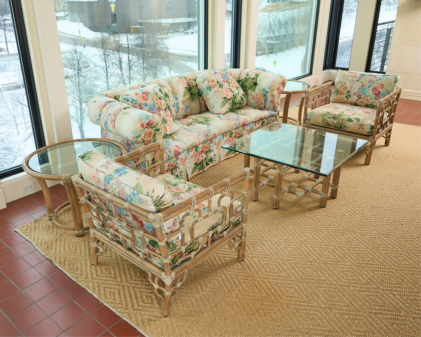 6 Pc Contemporary Upholstered & Faux Bamboo Suite: Six-piece contemporary salon suite with floral upholstery and faux bamboo frames. Including one button-tufted three-seat sofa, one pair of faux bamboo armchairs, one pair of circular side tables with 