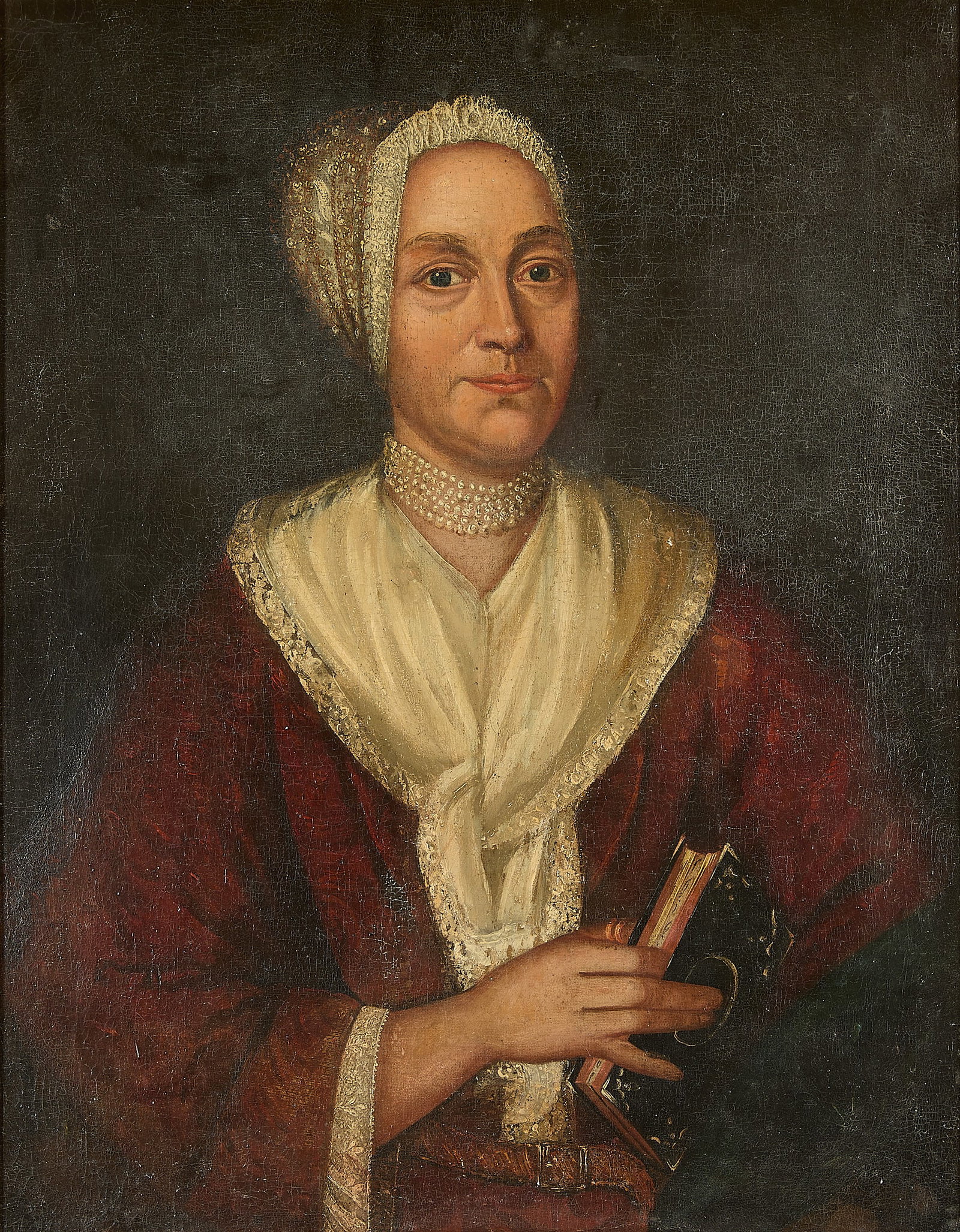 American School Portrait of a Woman Oil Painting: American School oil on canvas painting depicting the portrait of a woman in a red dress with a book in her right hand, 18th-19th century. With a toned handwritten paper label along the verso addressed