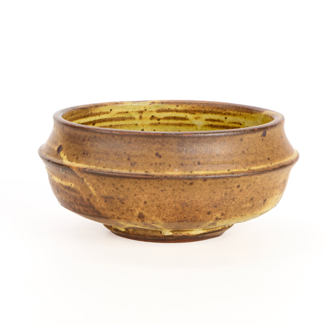 Warren MacKenzie Studio Pottery Bowl - Marked: Warren MacKenzie (American, 1924-2018). Studio pottery ceramic bowl with a flared shoulder, recessed neck, and lightly flared rim. Stoneware with a speckled yellow glaze. Stamped along the footrim War