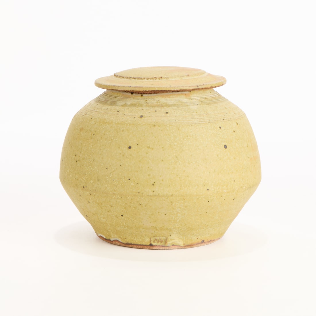 Warren MacKenzie Studio Pottery Lidded Jar Marked: Warren MacKenzie (American, 1924-2018). Studio ceramic lidded jar or vessel. Stoneware with a matte yellow glaze. Stamped along the footrim. Warren MacKenzie was a renowned Minnesota studio potter. A 
